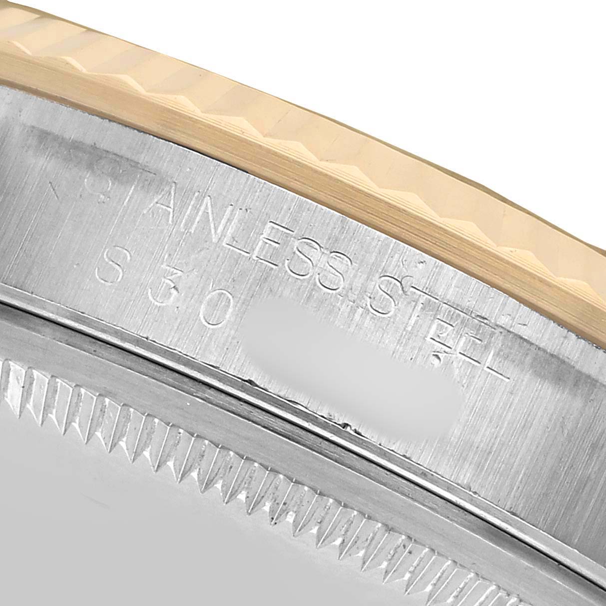 The image shows a close-up of the stainless steel and gold fluted bezel of a Rolex Datejust 16233 Men's Steel and Gold (two tone) Black Dial.