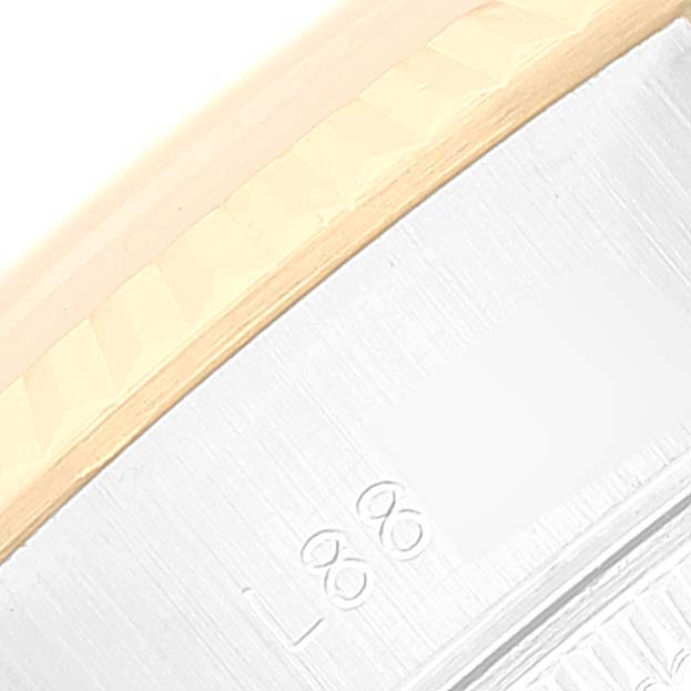 This close-up image shows part of the bezel and engraved markings on the side of the Rolex Datejust 69173 Women's Steel and Gold (two tone) White Dial 69173 Women's Steel and Gold (two tone) White Dial watch case.