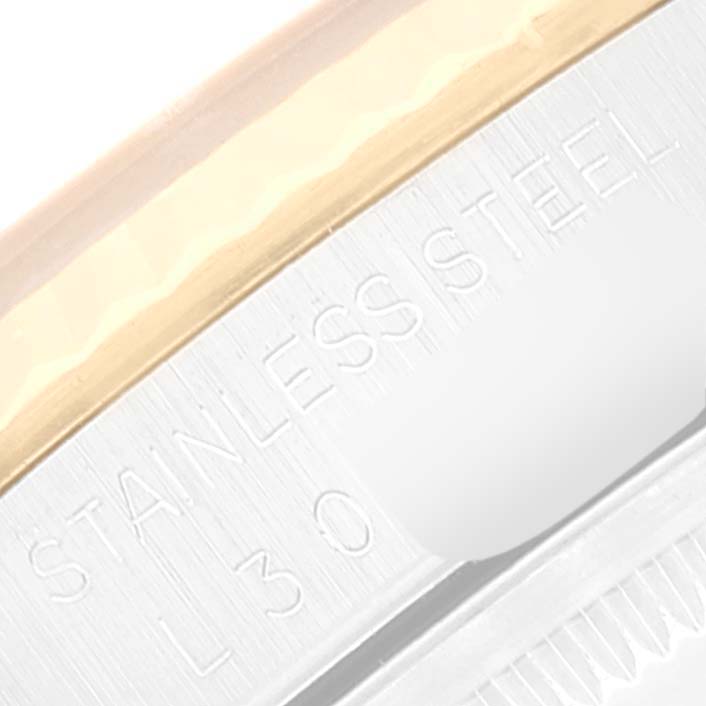 This image shows a close-up of the side engraving and part of the bezel of a Rolex Datejust 16233 Men's Steel and Gold (two tone) White Dial 16233 Men's Steel and Gold (two tone) White Dial watch.