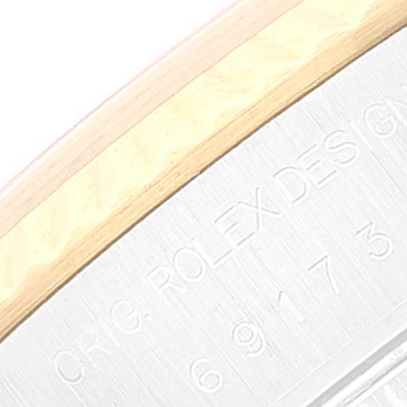 This image shows a close-up of the side engraving and part of the bezel on a Rolex Datejust 69173 Women's Steel and Gold (two tone) White Dial 69173 Women's Steel and Gold (two tone) White Dial model.