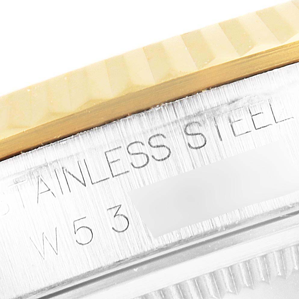 This close-up image shows the bezel and stainless steel case of a Rolex Datejust 16233 Men's Steel and Gold (two tone) White Dial 16233 Men's Steel and Gold (two tone) White Dial watch.