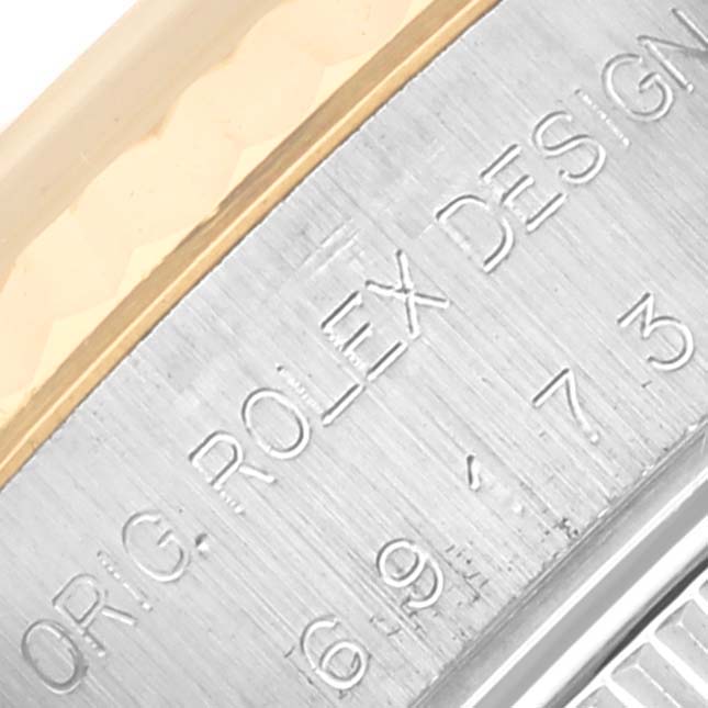 The image shows a close-up of the side of a Rolex Datejust 69173 Women's Steel and Gold (two tone) Blue Dial 69173 Women's Steel and Gold (two tone) Blue Dial watch, highlighting the engraved model details.