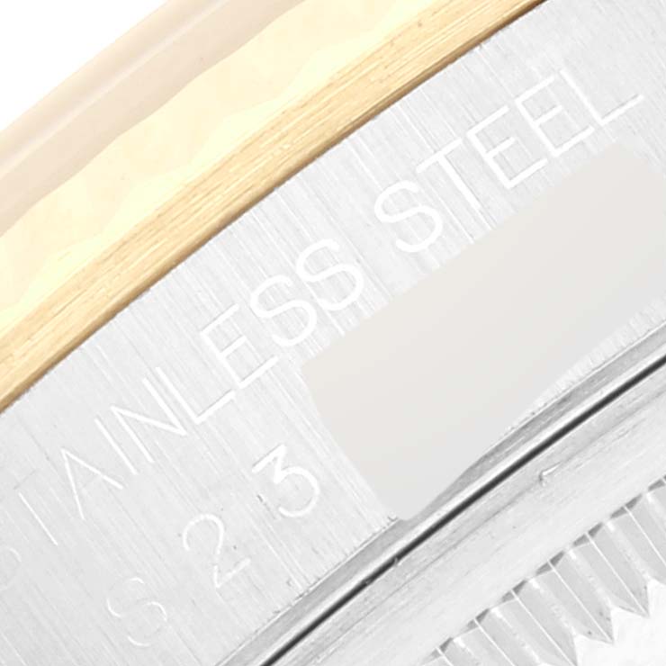 This close-up image shows the engraved stainless steel case edge of a Rolex Datejust 16233 Men's Steel and Gold (two tone) White Dial 16233 Men's Steel and Gold (two tone) White Dial watch.