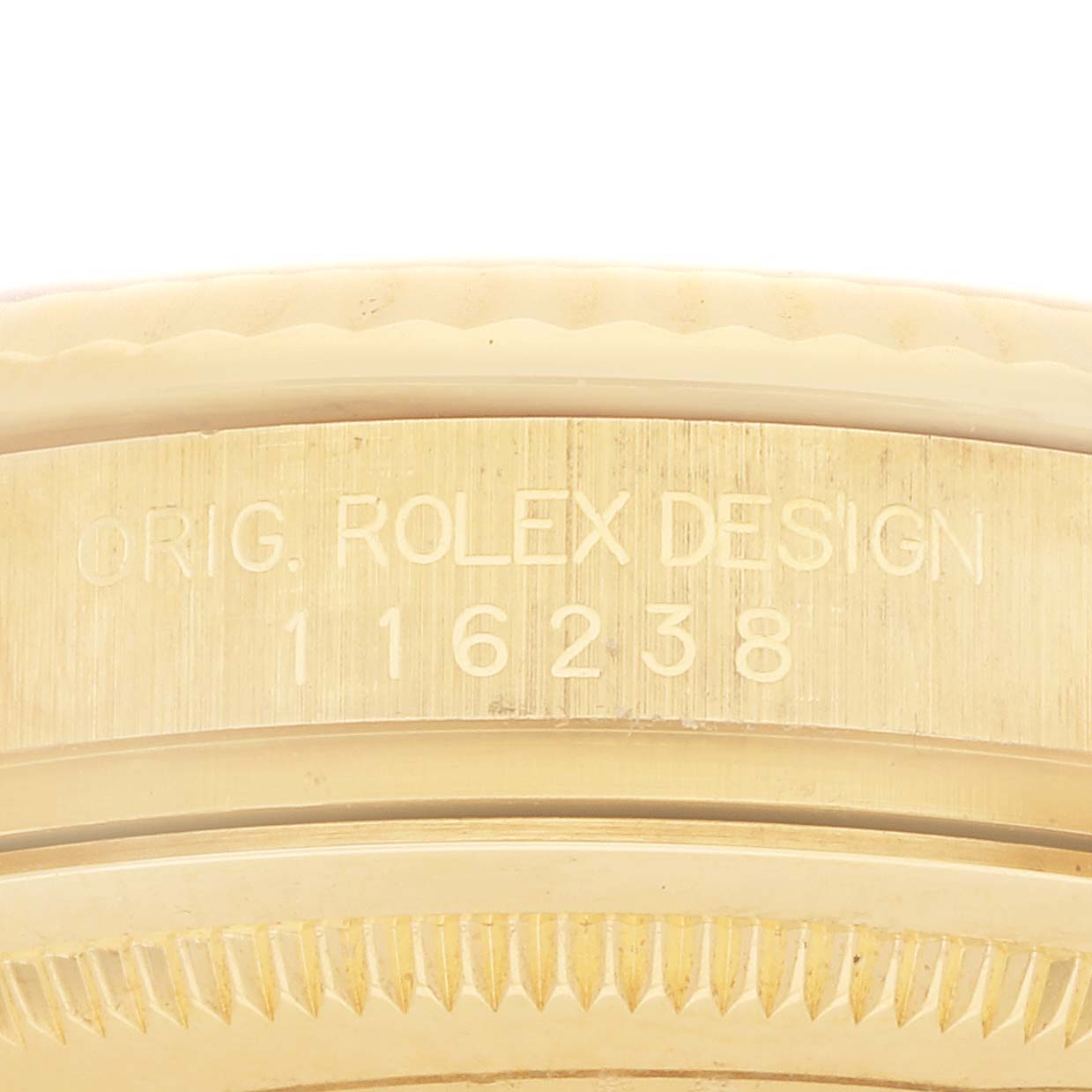 The image shows a close-up of the side engraving on a Rolex Datejust 116238 Women's Yellow Gold Champagne Dial bezel, featuring "ORIG. ROLEX DESIGN" and the model number.
