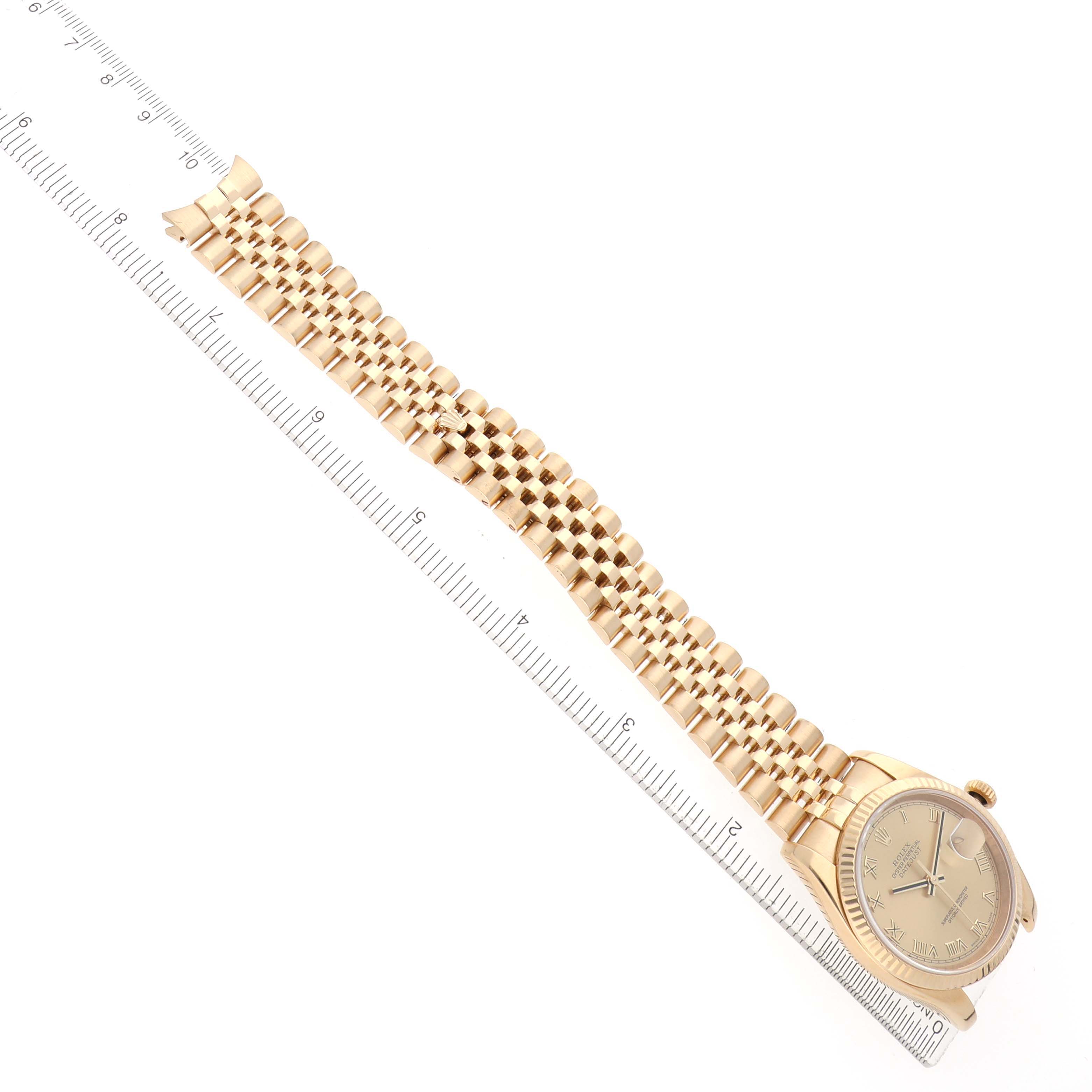 The Rolex Datejust 116238 Women's Yellow Gold Champagne Dial watch is displayed at an angle showing the full bracelet, case, and dial, next to a ruler for scale.