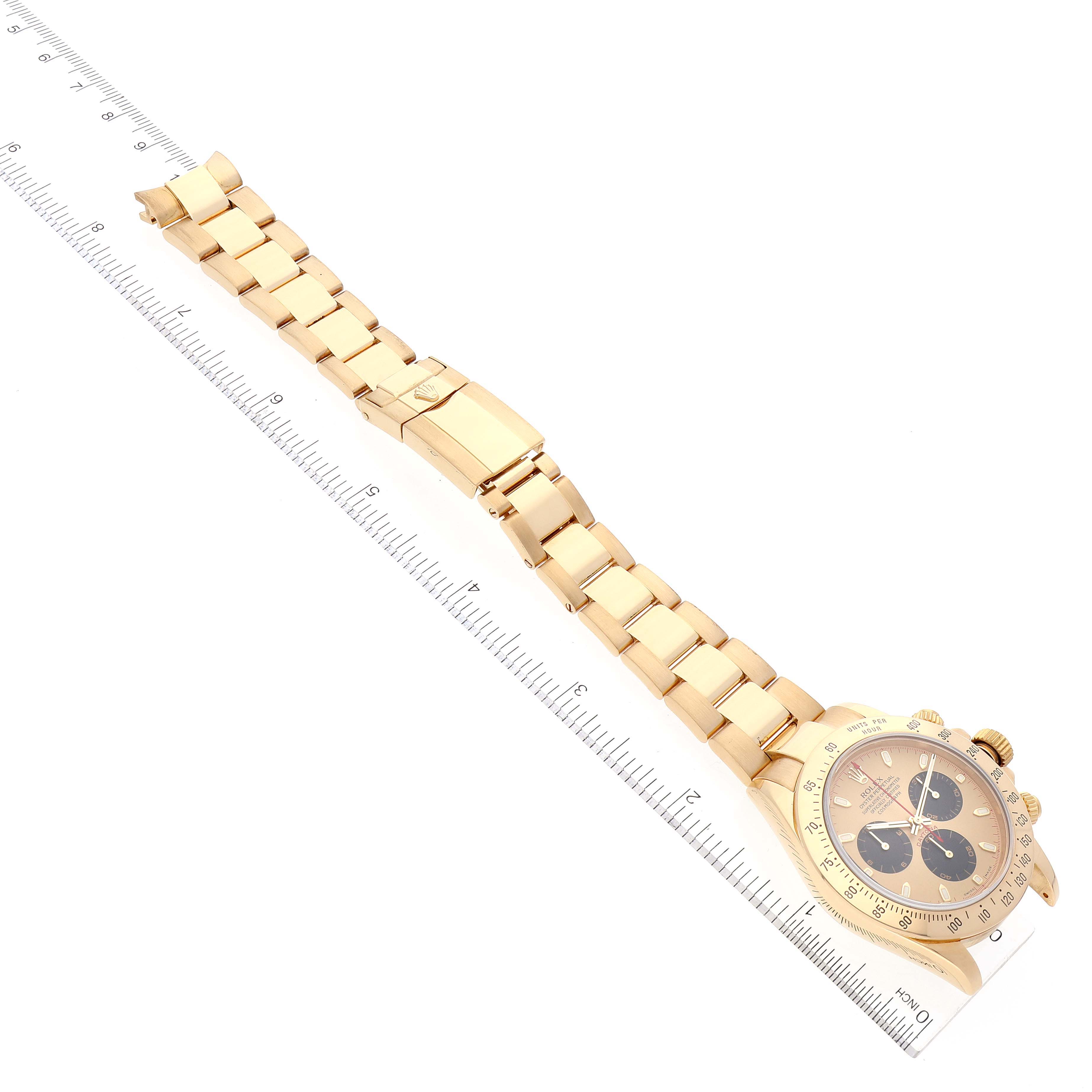 The image shows a Rolex Daytona 116528 Men's Yellow Gold Champagne Dial 116528 Men's Yellow Gold Champagne Dial watch laid flat with a ruler for measurement alongside.