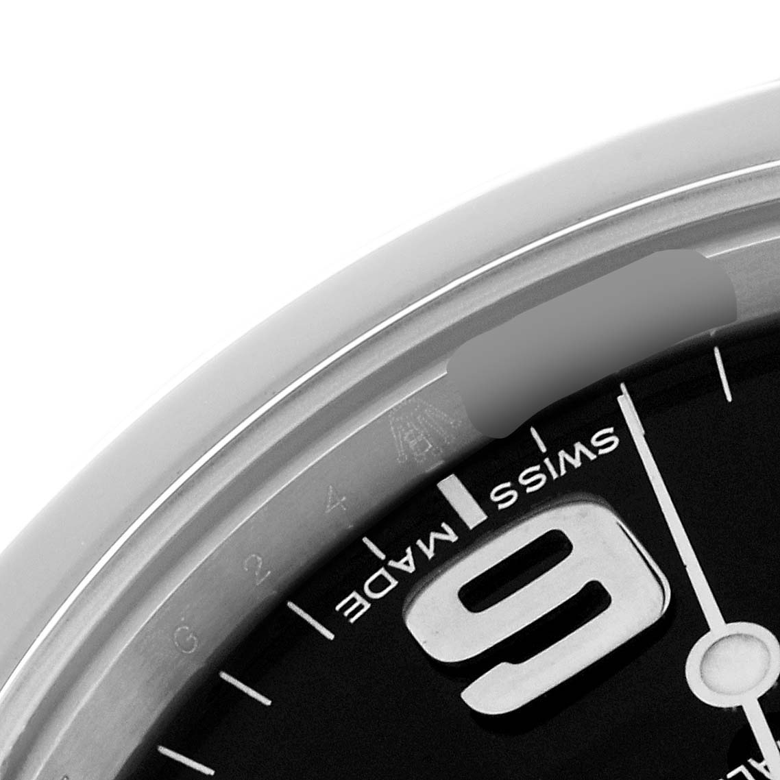 The image shows a close-up view of the dial and part of the bezel of a Rolex Explorer 214270 Men's Stainless Steel Black Dial 214270 Men's Stainless Steel Black Dial watch, highlighting the numeral 6 and "SWISS MADE."