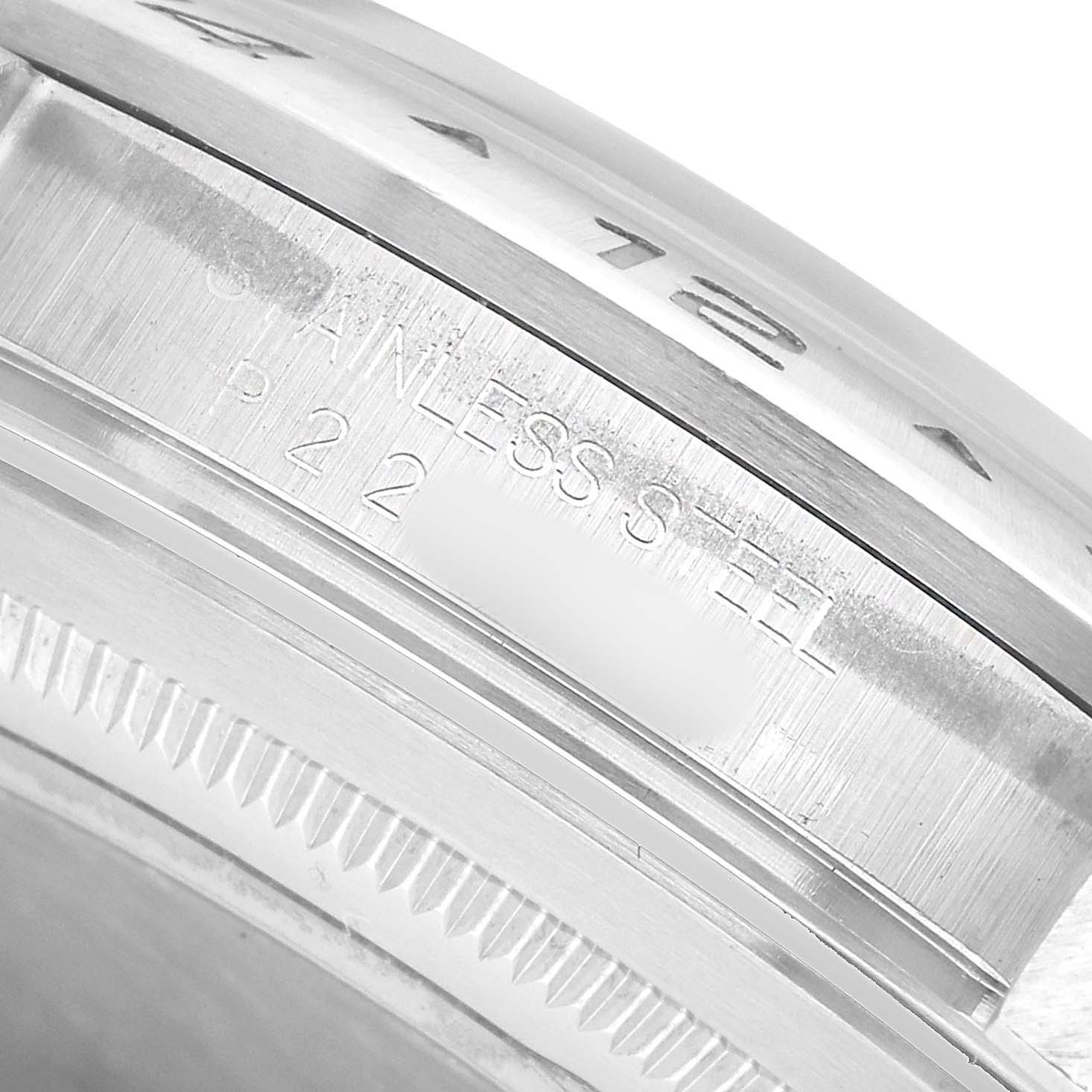 The image shows a close-up of the side of a Rolex Explorer 16570 Men's Stainless Steel White Dial watch case, focusing on the bezel and engraved details.