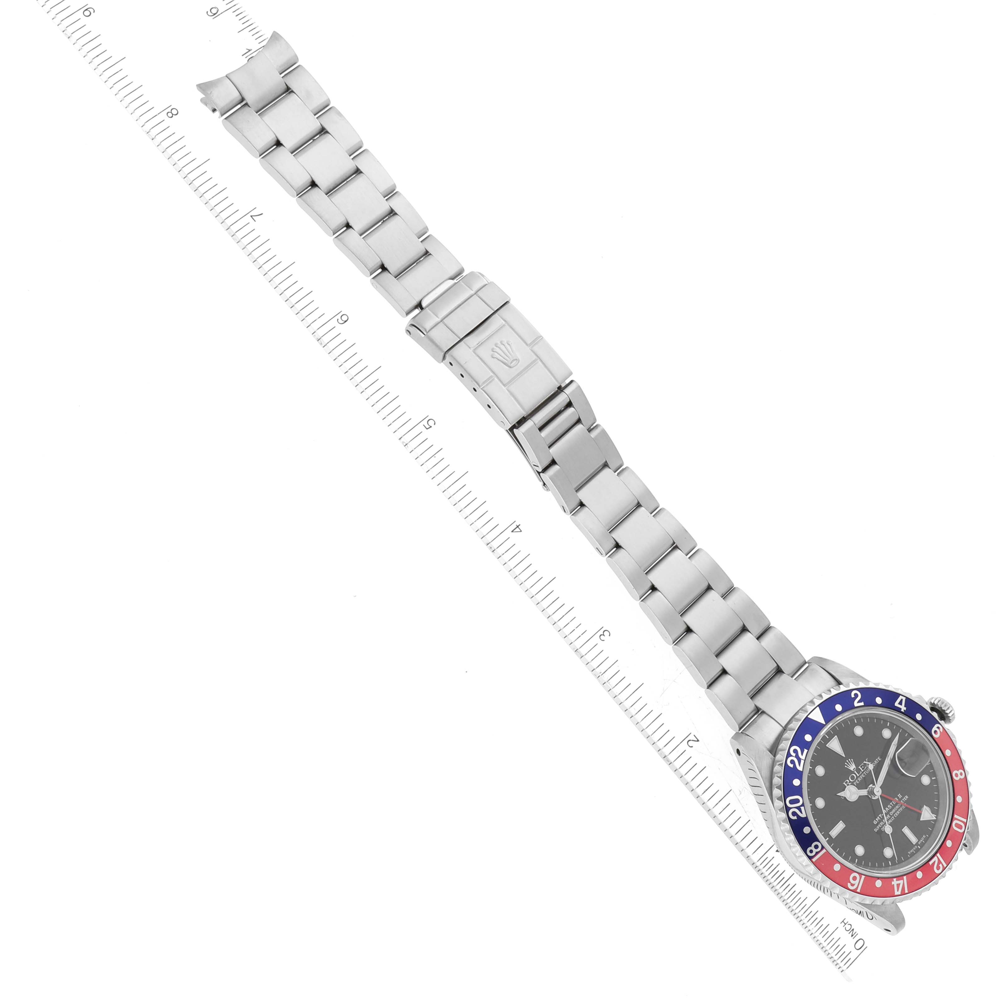 The image shows a top-down view of a Rolex GMT-Master 16710 Men's Stainless Steel Black Dial 16710 Men's Stainless Steel Black Dial watch, displaying its stainless steel bracelet and a bezel with red and blue segments.