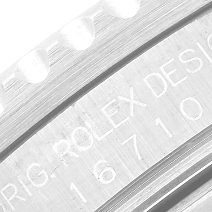 This close-up image of a Rolex GMT-Master 16710 Men's Stainless Steel Black Dial 16710 Men's Stainless Steel Black Dial watch shows the engraved text on the side of the case.