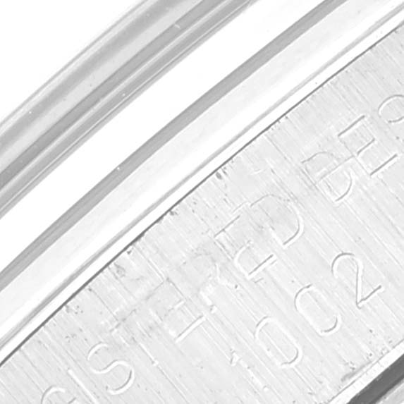 This close-up image showcases the engraved metal band of a Vintage Collection model by Rolex at an angle.