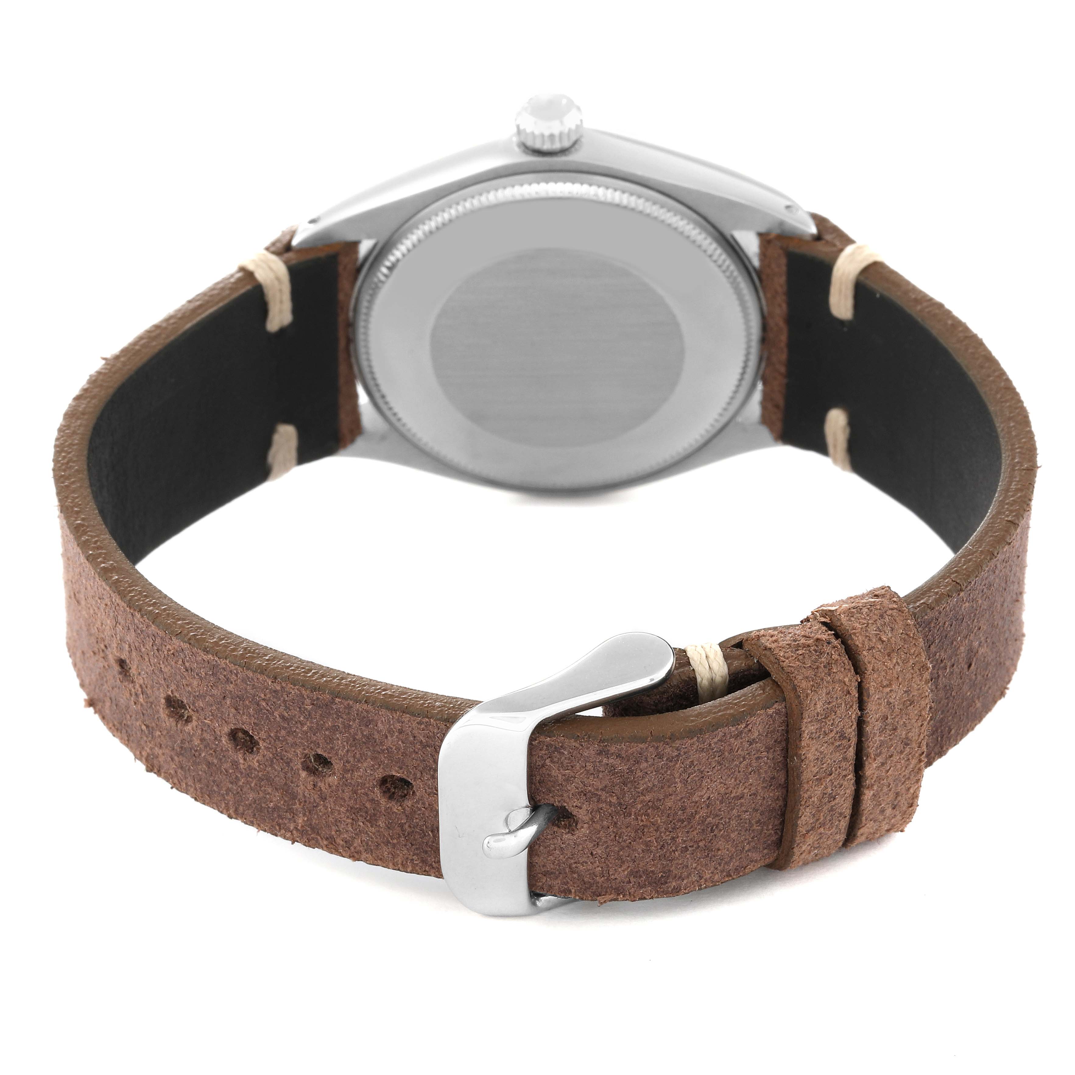 The image shows the back view of a Rolex Vintage Collection 1002 Men's Stainless Steel Silver Dial 1002 Men's Stainless Steel Silver Dial watch, highlighting the case back, crown, and brown leather strap with buckle.