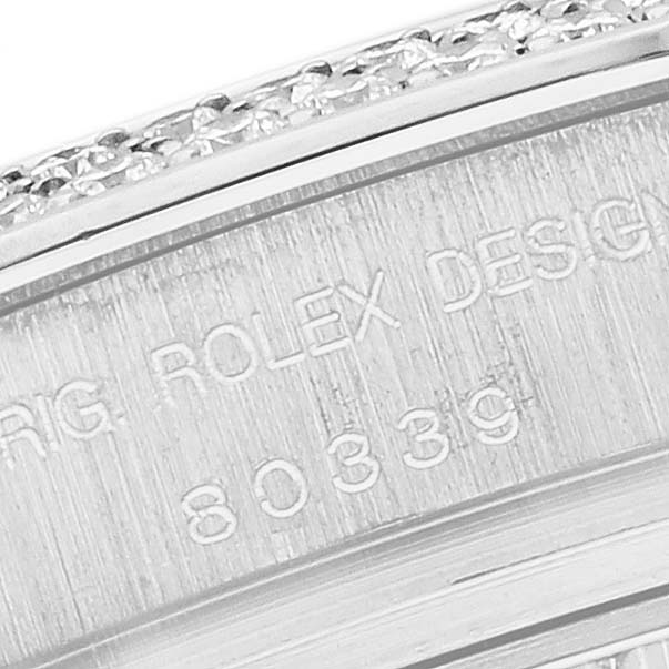 The image shows a close-up of the engraved side of a Rolex Pearlmaster 80339 Women's White Gold Mother of Pearl Dial watch, highlighting text and part of the bezel.