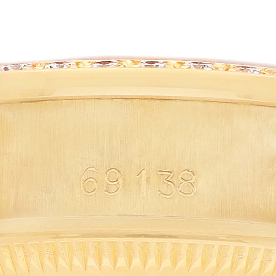 The image shows a close-up of the engraved side of a Rolex President 69138 Women's Yellow Gold Champagne Dial model, focusing on the model number.