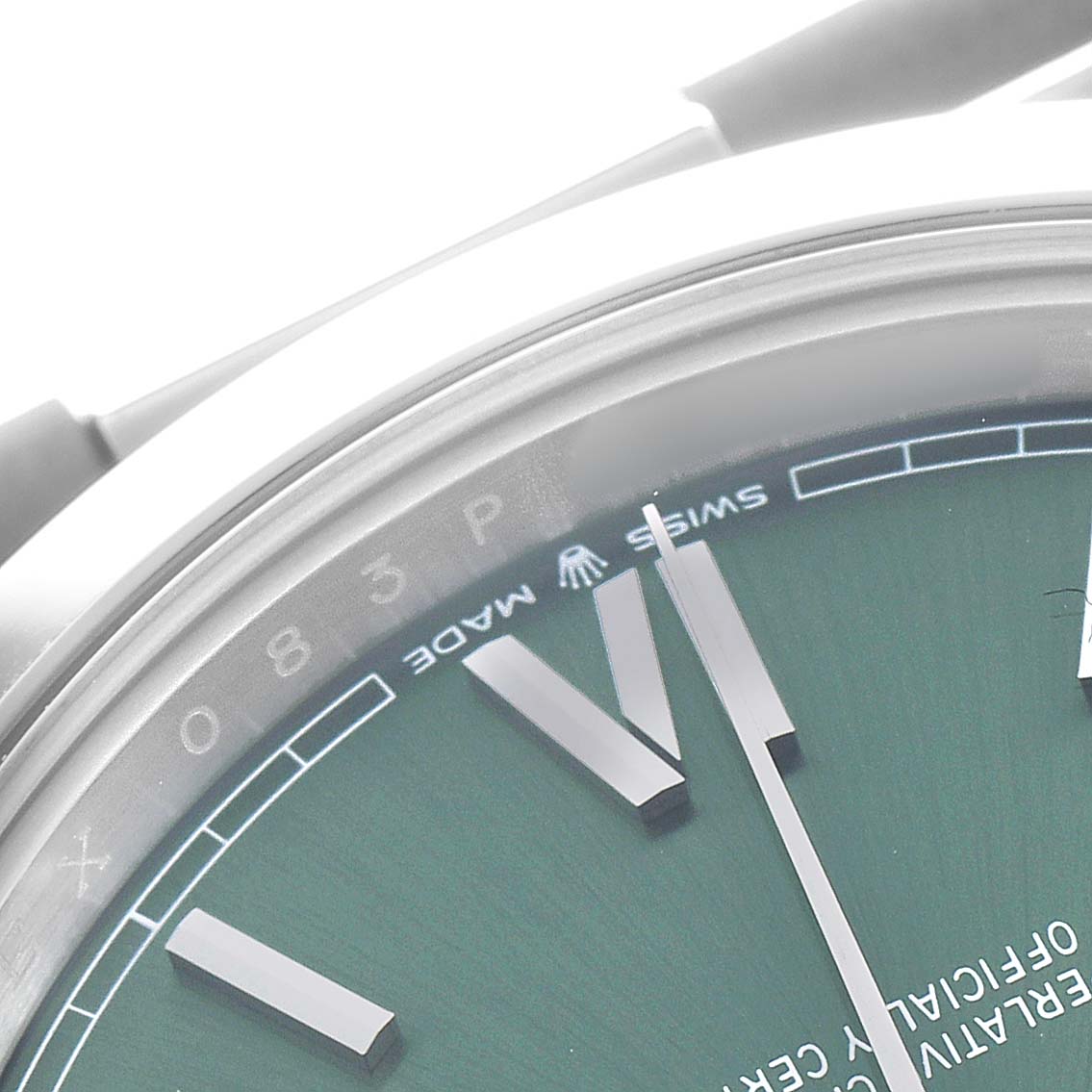 The image shows a close-up of the dial and indices of a Rolex President 228206 Men's Platinum Green Dial watch from an angled top view.