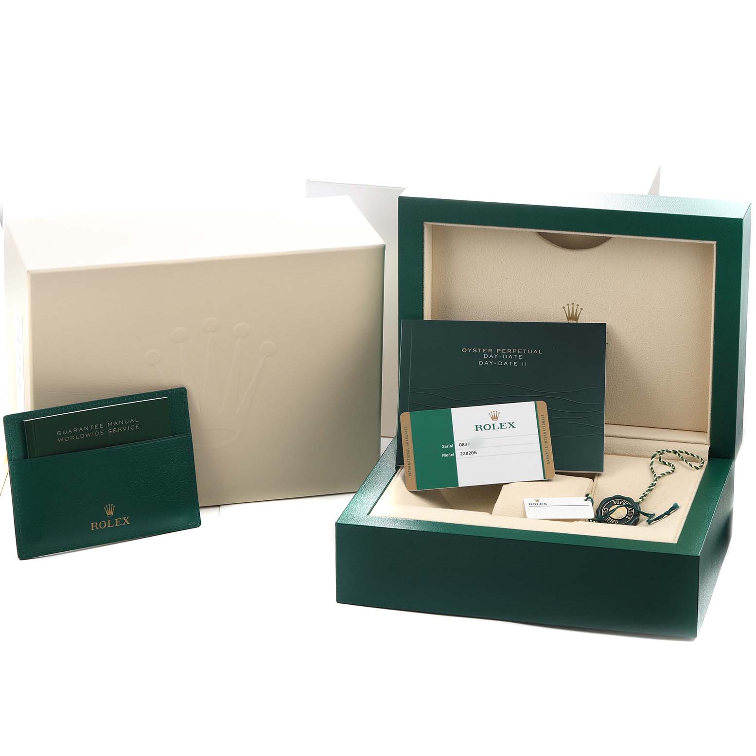 The image shows the packaging and accessories of a Rolex President 228206 Men's Platinum Green Dial model, including a box, warranty card, and manuals.