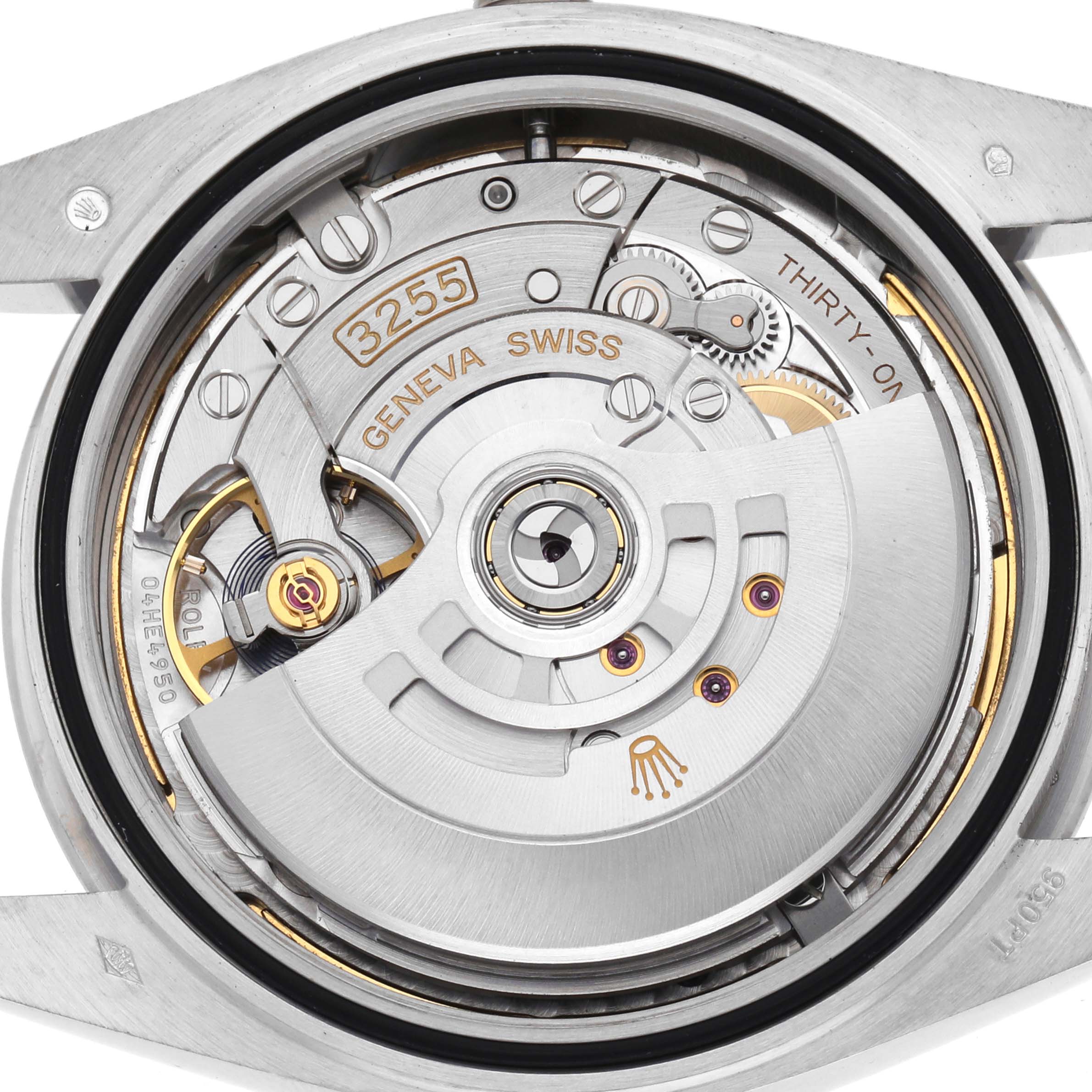 The image shows the movement of a Rolex President 228206 Men's Platinum Green Dial watch viewed from the back, highlighting gears and engravings.