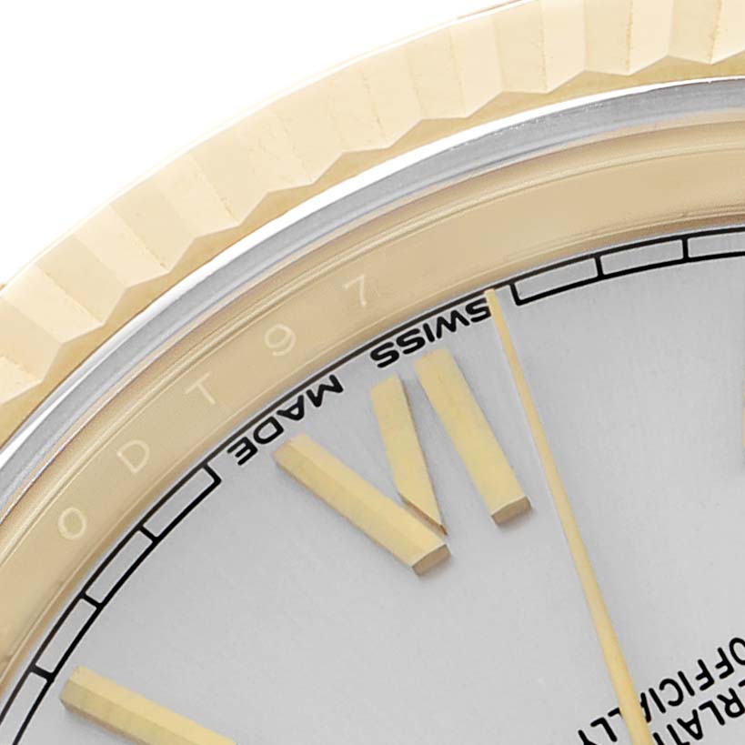 The image shows a close-up of the Rolex President 228238 Men's Yellow Gold Silver Dial model, focusing on part of the bezel and dial with the minute markers.