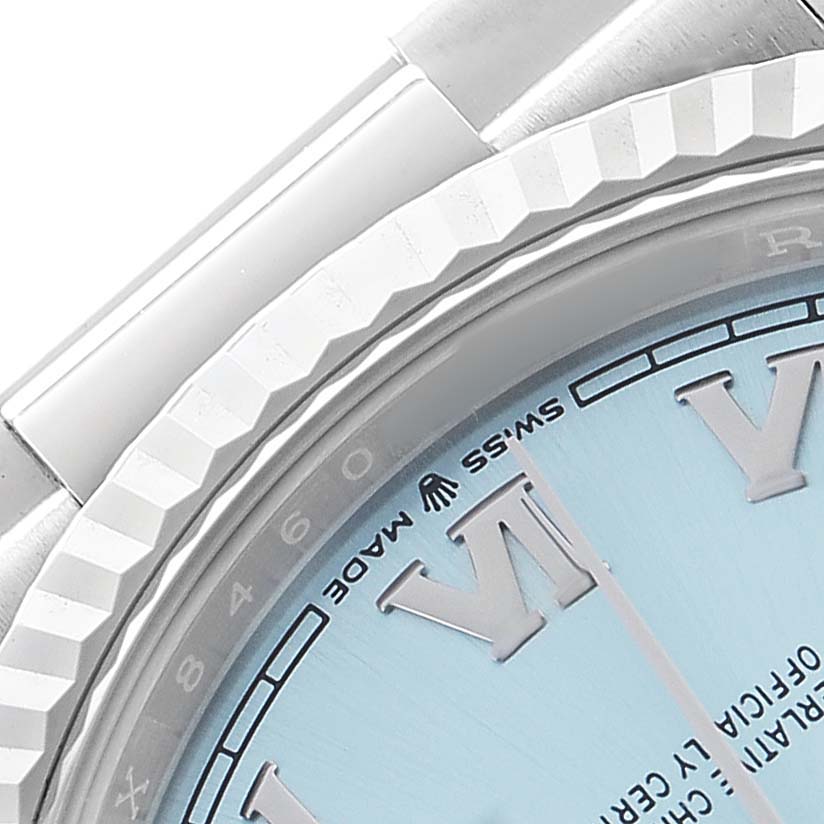 The image shows a close-up of the Rolex President 128236 Men's Platinum Blue Dial model's fluted bezel and partial dial with Roman numerals.
