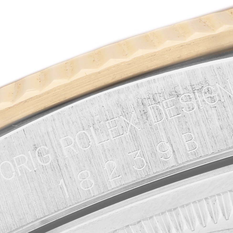 The image shows a close-up of the edge and engraved markings on the bezel and case back of a Rolex President 18239 Men's Steel and Gold (two tone) Champagne Dial watch.