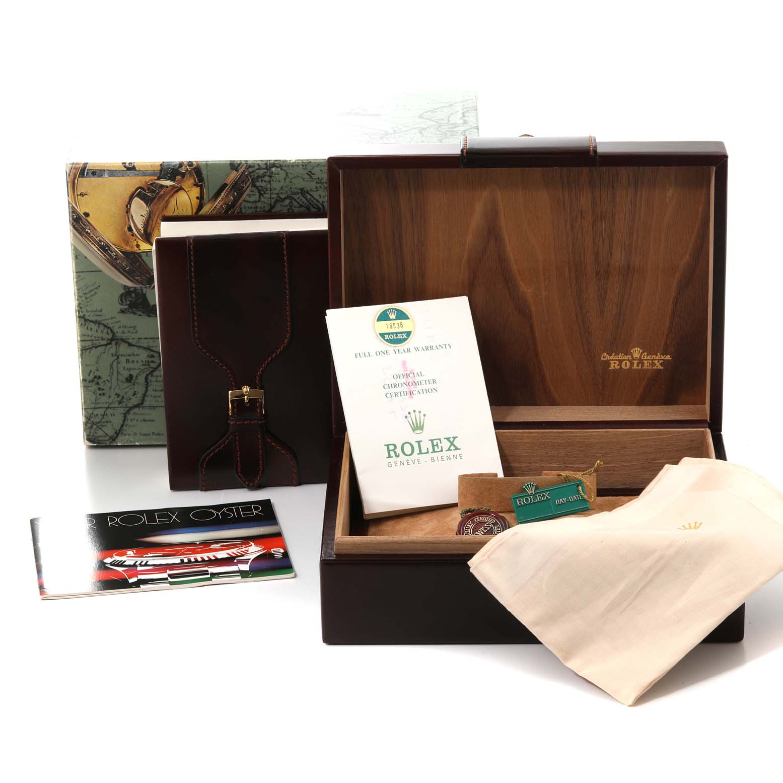 The image shows the accessories and packaging for a Rolex President 18038 Men
s Yellow Gold Champagne Dial 18038 Men
s Yellow Gold Champagne Dial watch, including a wooden box, paperwork, and a cloth.