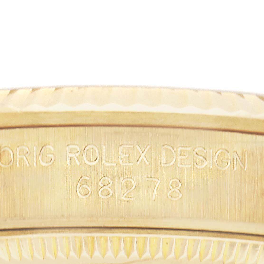 The image shows a close-up of the case edge of a Rolex President 68278 Women's Yellow Gold Champagne Dial model with the design number engraved.