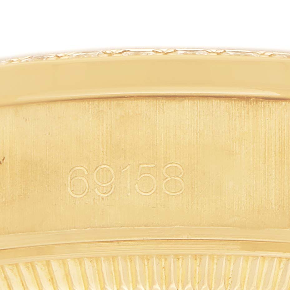 The image shows the side of a Rolex President 69158 Women's Yellow Gold Champagne Dial watch case, focusing on the model number "69158" engravings.