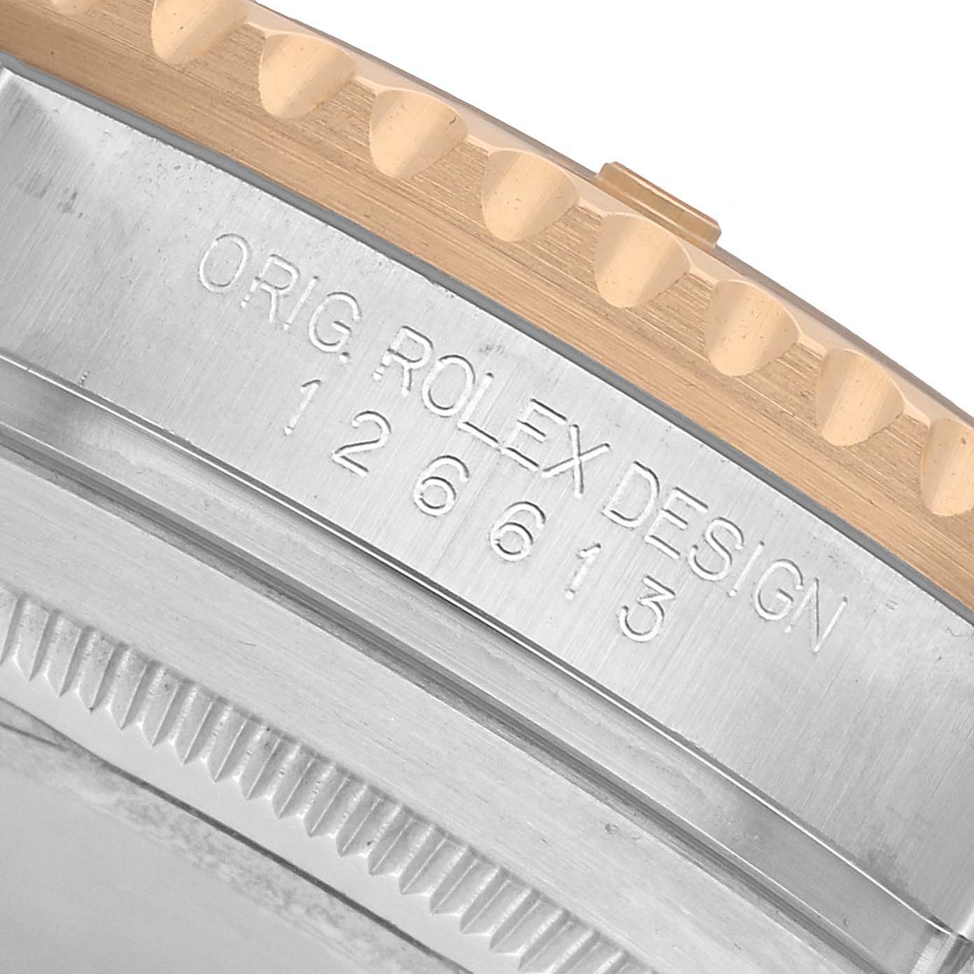 The image shows a close-up of the side detail and bezel edge of a Rolex Submariner 126613 Men's Steel and Gold (two tone) Black Dial, highlighting the engraved model number.