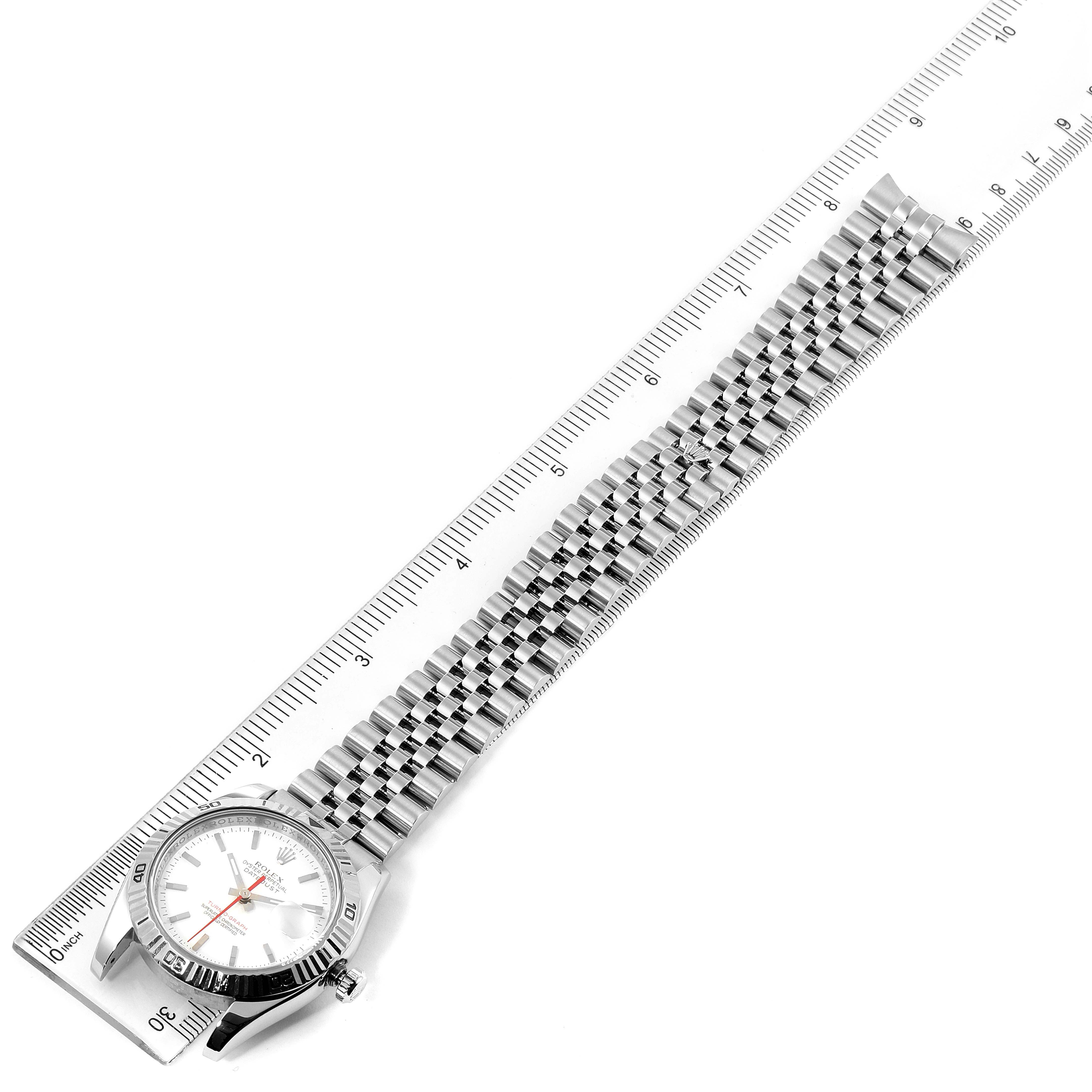 The image shows a Rolex Turn-o-Graph 116264 Men
s Stainless Steel White Dial 116264 Men
s Stainless Steel White Dial watch from a top-down angle, featuring the face and bracelet laid out beside a ruler.