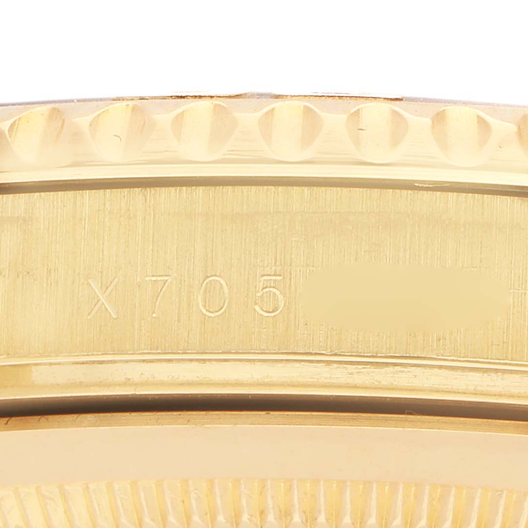 The image shows a close-up of the gold bezel and case edge of a Rolex Yacht-Master 16628B Men's Yellow Gold White Dial watch, highlighting the engraving "X705."
