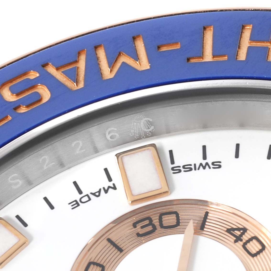 Close-up of the dial and bezel of a Rolex Yacht-Master 116681 Men
s Steel and Gold (two tone) White Dial 116681 Men
s Steel and Gold (two tone) White Dial watch, showing part of the minute markers and "YACHT-MASTER" inscription.