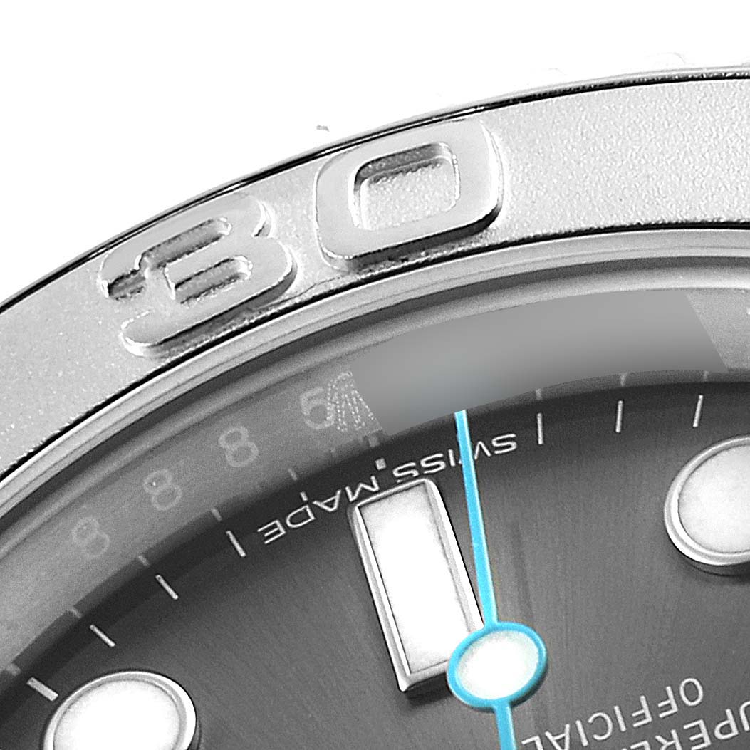 This close-up image of a Rolex Yacht-Master 116622 Men
s Stainless Steel Grey Dial 116622 Men
s Stainless Steel Grey Dial watch shows part of the bezel, dial, and minute hand.