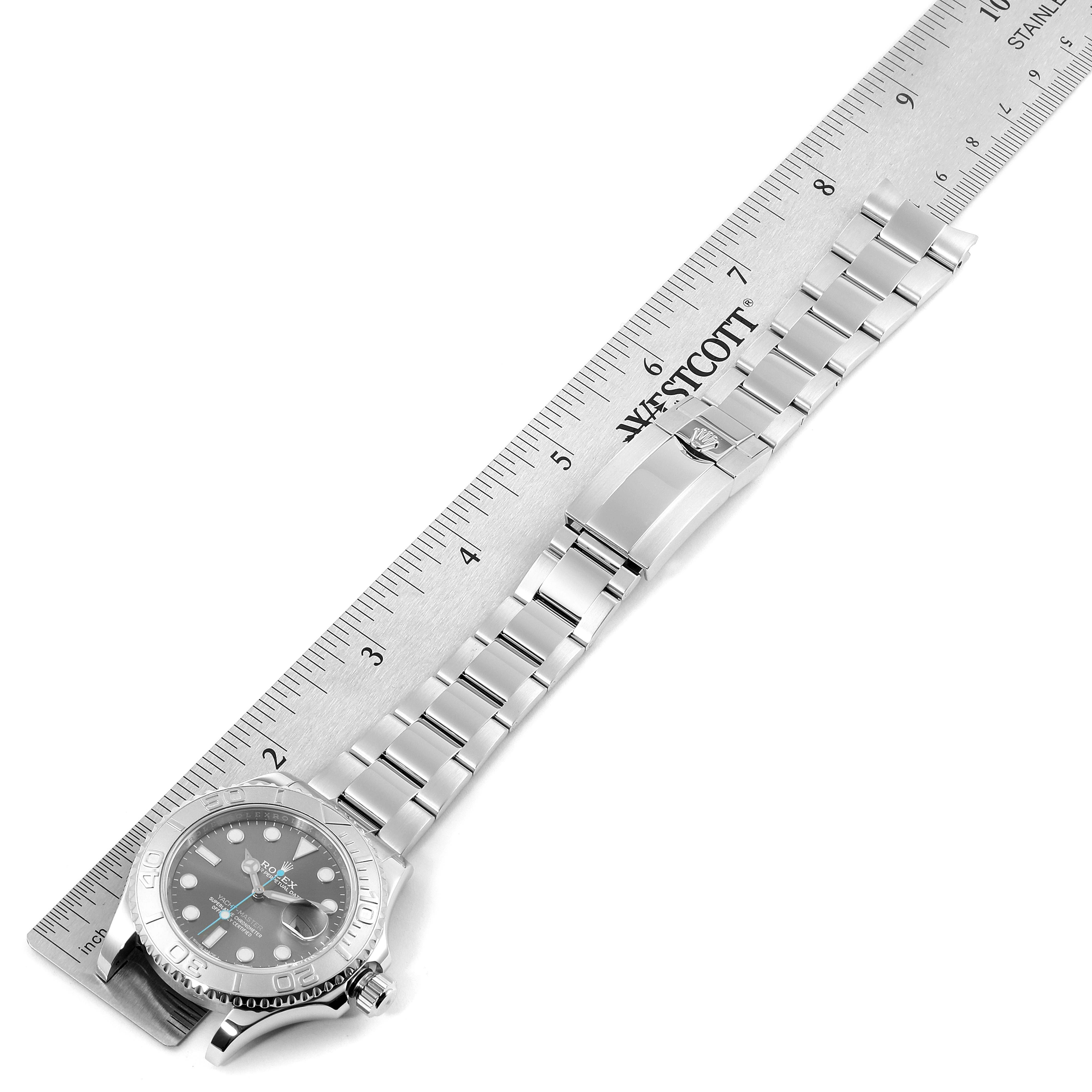 This image shows the Rolex Yacht-Master 116622 Men
s Stainless Steel Grey Dial 116622 Men
s Stainless Steel Grey Dial watch laid flat with its bracelet extended, alongside a ruler for scale.