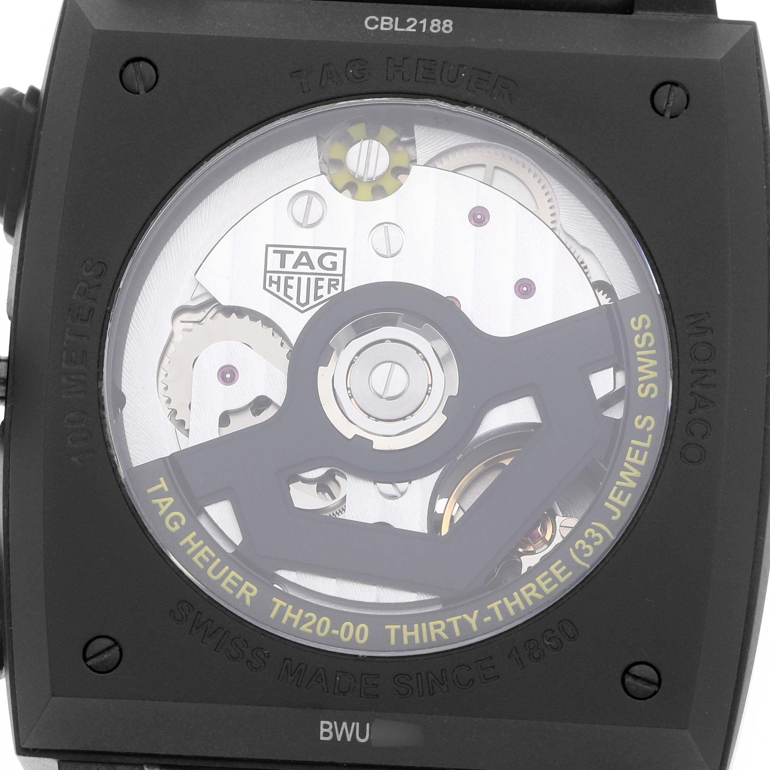 The image shows the case back of the Tag Heuer Monaco CBL2188.FT6261 Men's Titanium Blue Dial model, revealing its automatic movement and internal mechanisms.