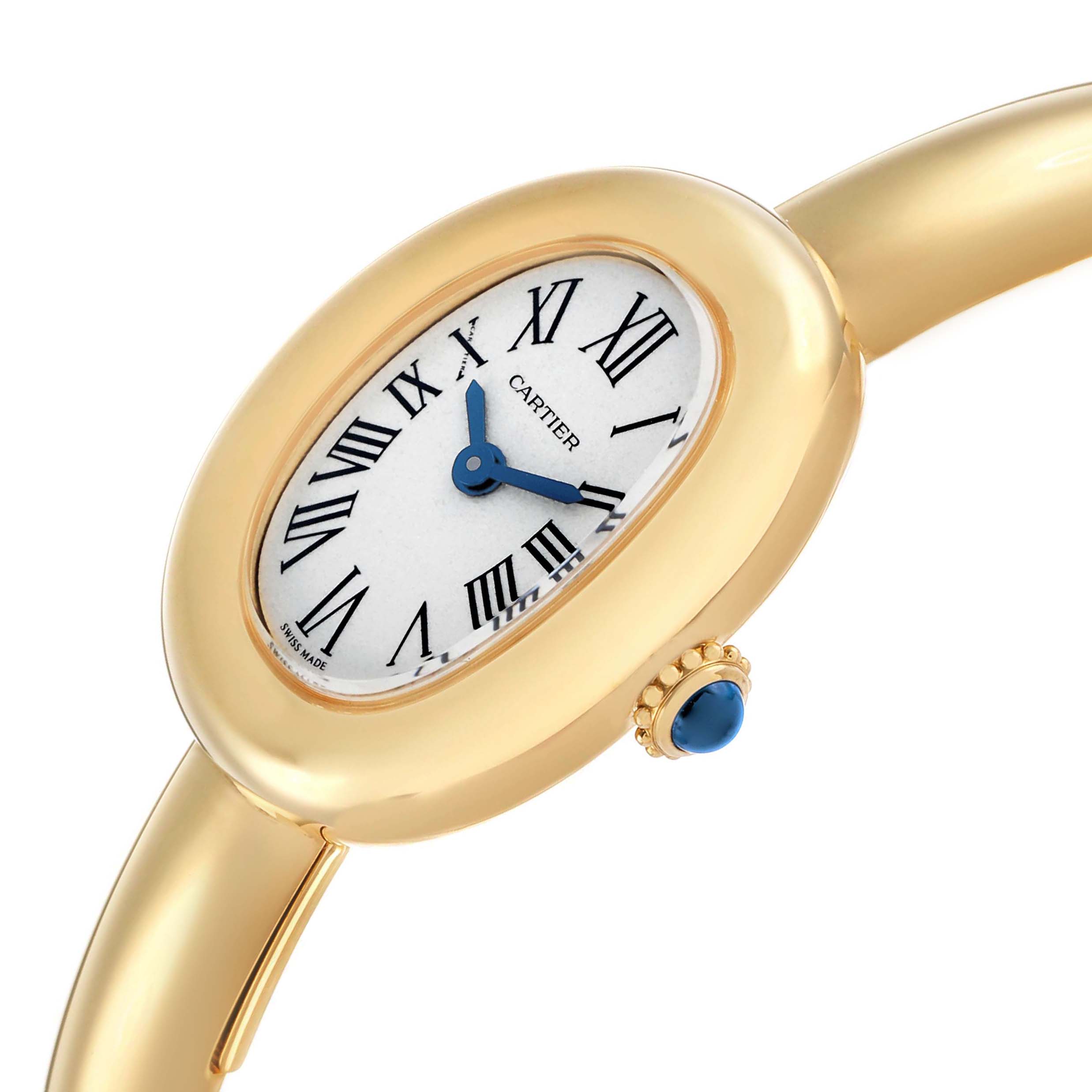 The Cartier Baignoire WGBA0044 Women's Yellow Gold Silver Dial watch is shown at an angle displaying the oval face, Roman numerals, and a gold case with a blue cabochon crown.