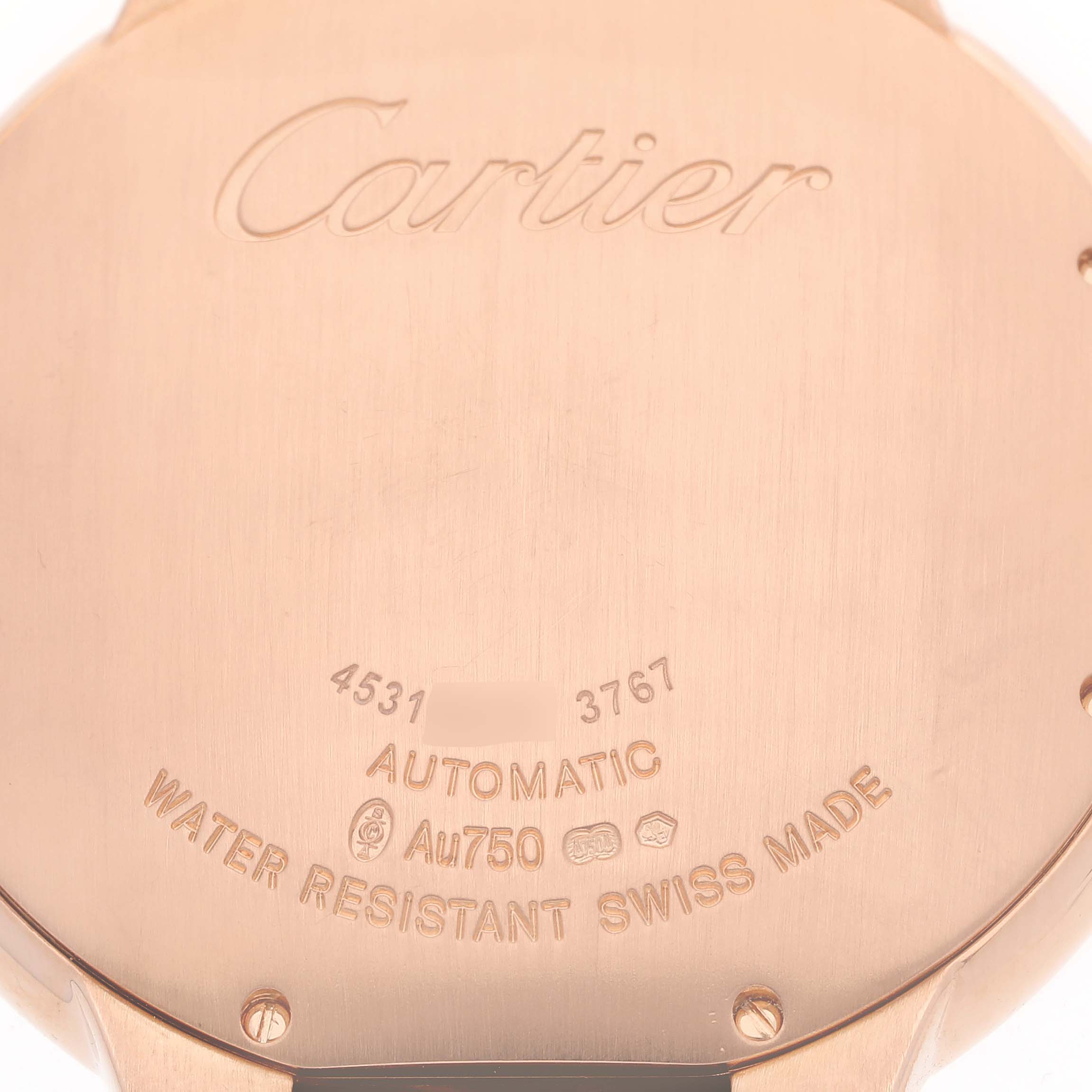 The image shows the back of a Ballon Bleu by Cartier, highlighting engravings and details like water resistance and material.