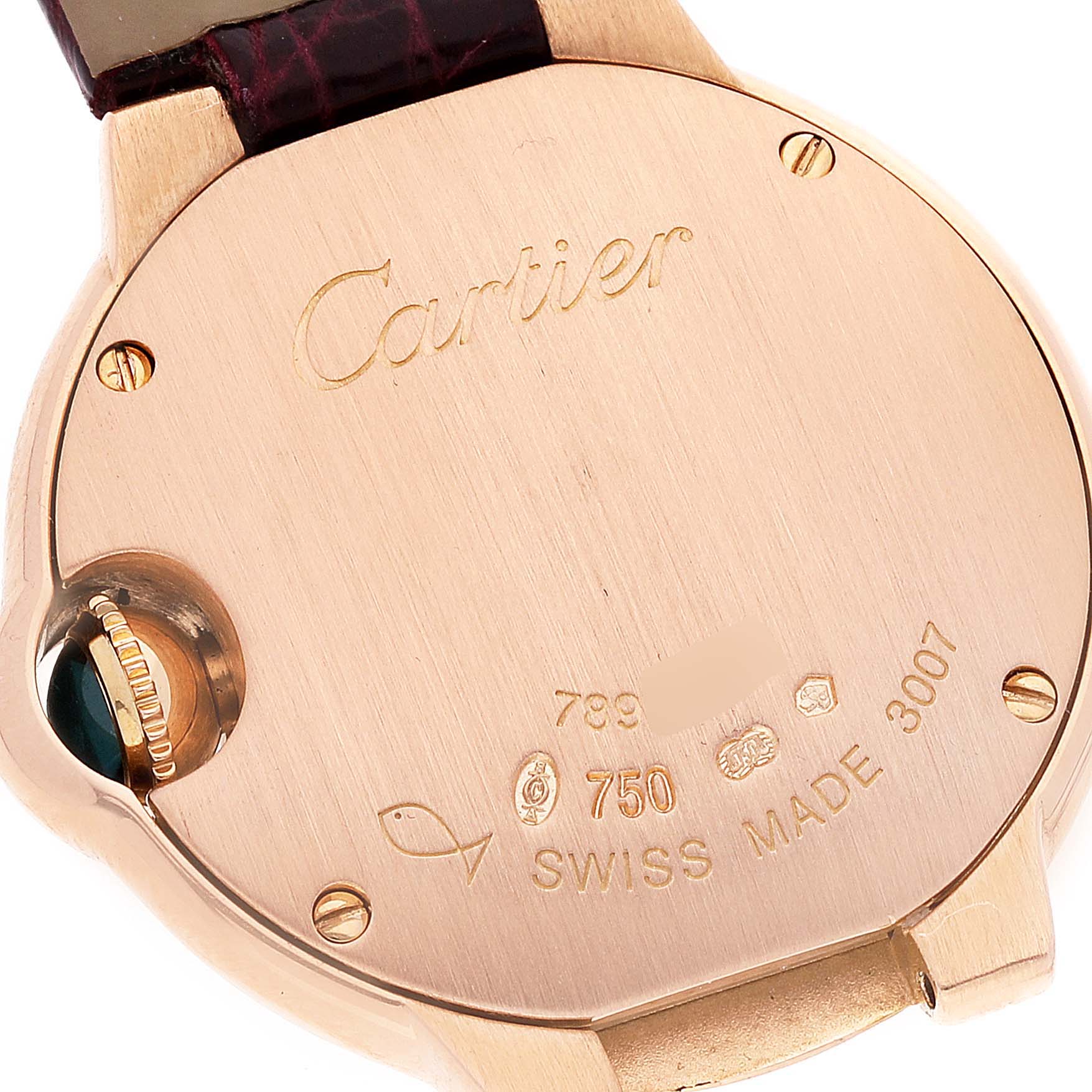 This image shows the back case of a Ballon Bleu model watch by Cartier, featuring engravings and crown details.