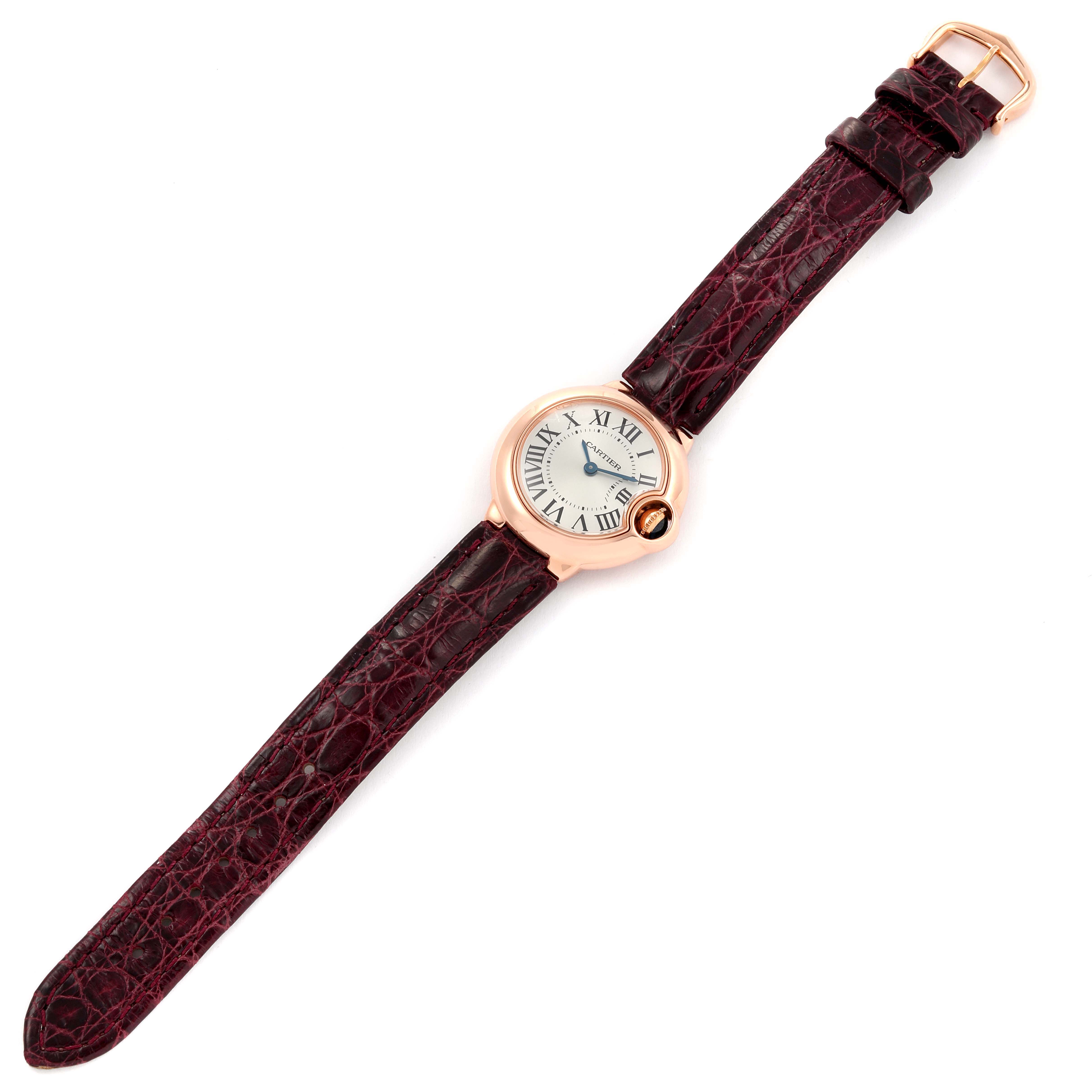 The image shows a top-down angle of a Cartier Ballon Bleu W6900256 Women's Rose Gold Silver Dial W6900256 Women's Rose Gold Silver Dial watch with a round face and a brown leather strap.