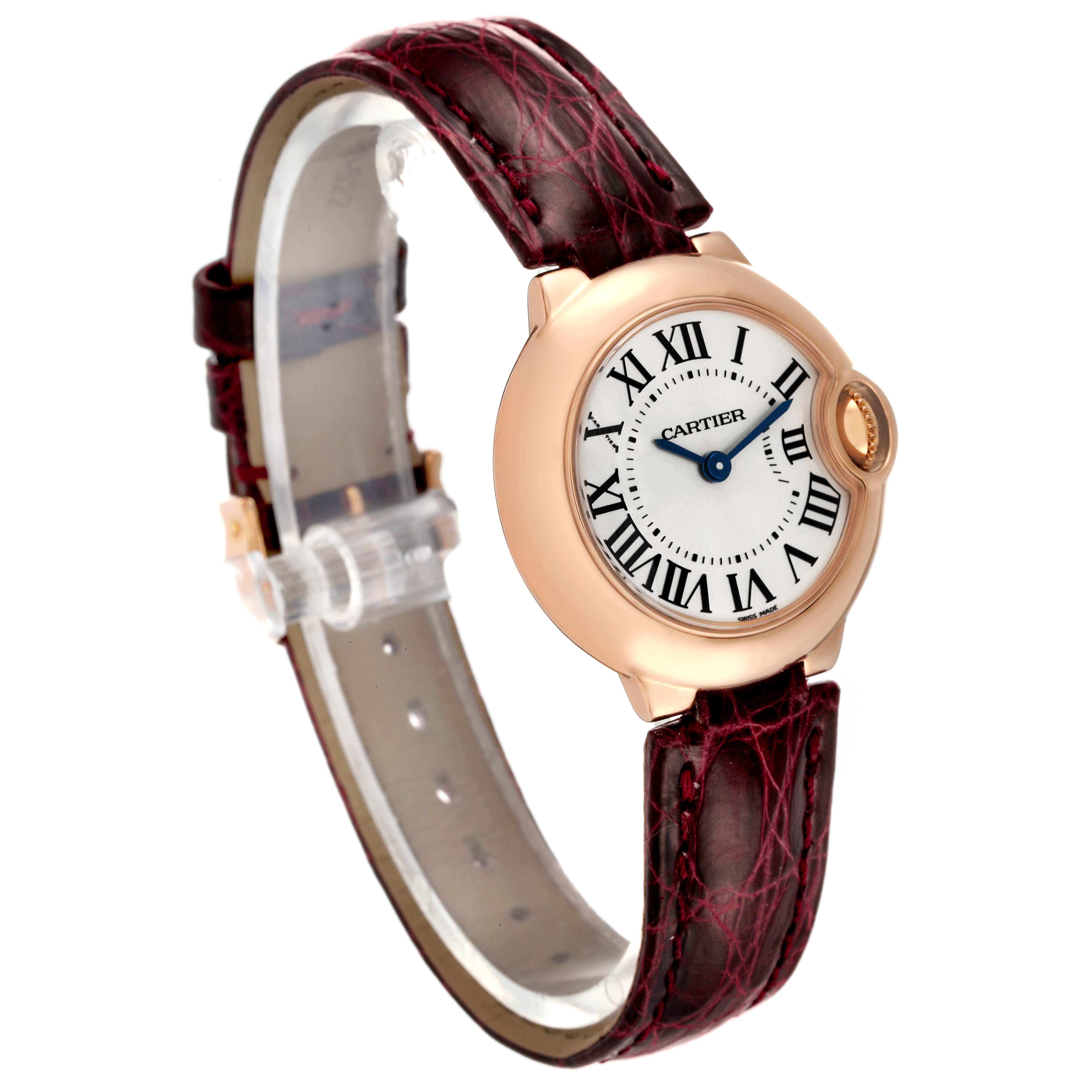 This image shows a side angle of the Cartier Ballon Bleu W6900256 Women's Rose Gold Silver Dial W6900256 Women's Rose Gold Silver Dial watch, highlighting its rose gold case, Roman numeral dial, and burgundy leather strap.