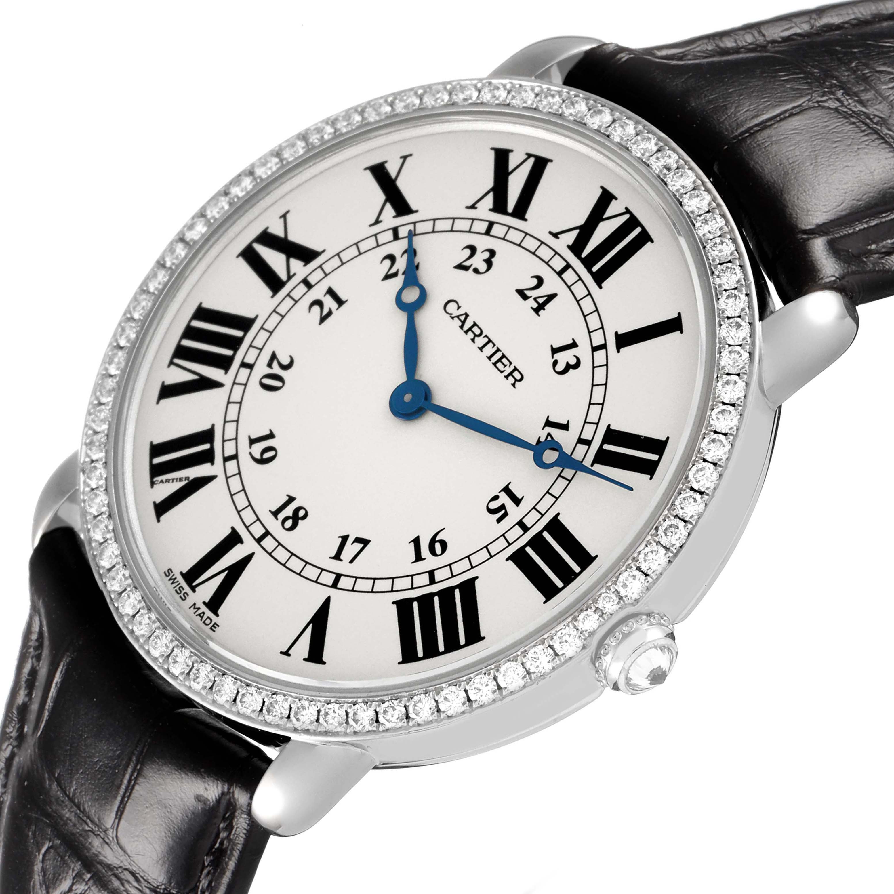 The Cartier Ronde WR000551 Women's White Gold Silver Dial watch is shown at a slight angle, displaying the face, Roman numerals, diamond bezel, and a leather strap.