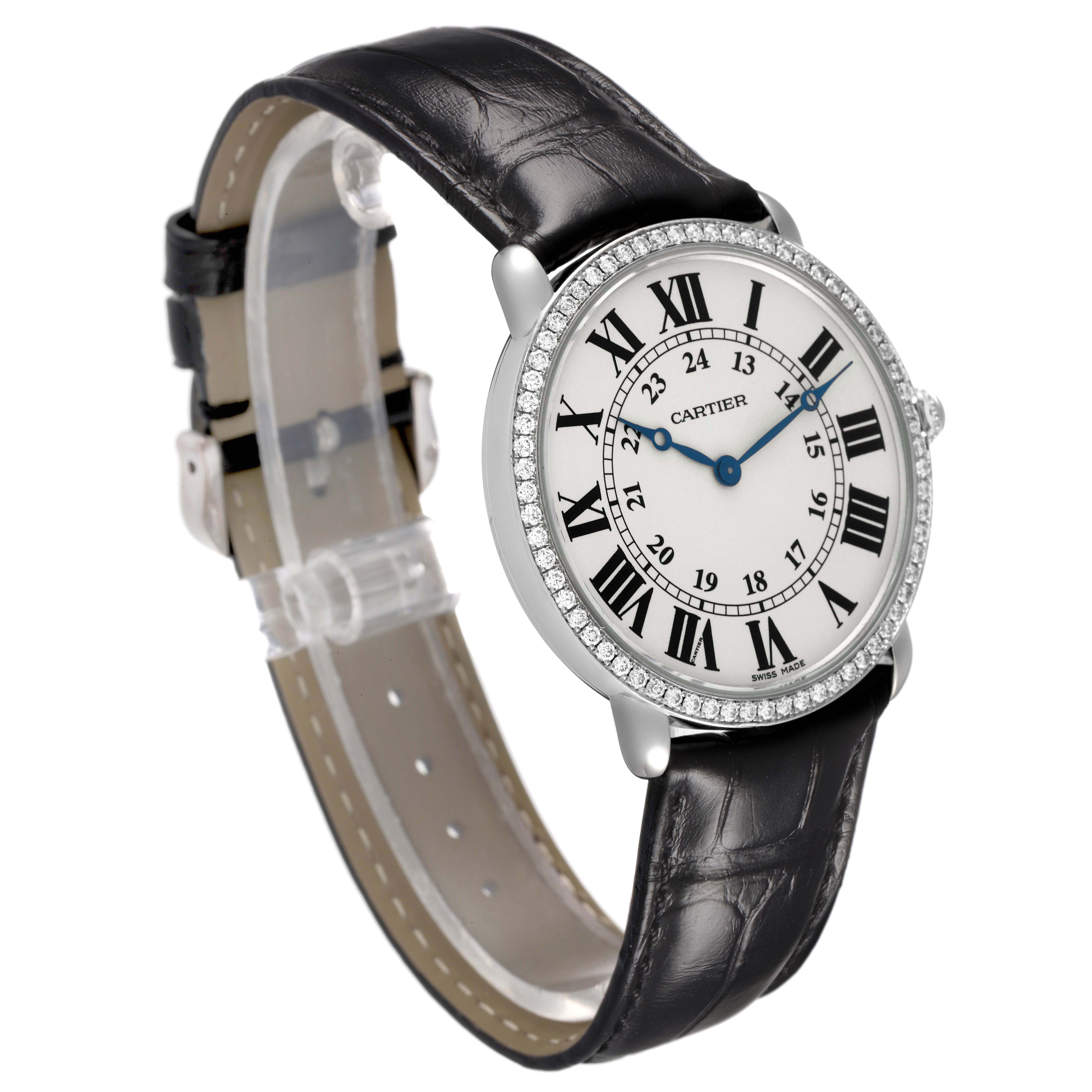 The Cartier Ronde WR000551 Women's White Gold Silver Dial watch is shown at an angled side view, featuring a diamond bezel, Roman numerals, and leather strap.