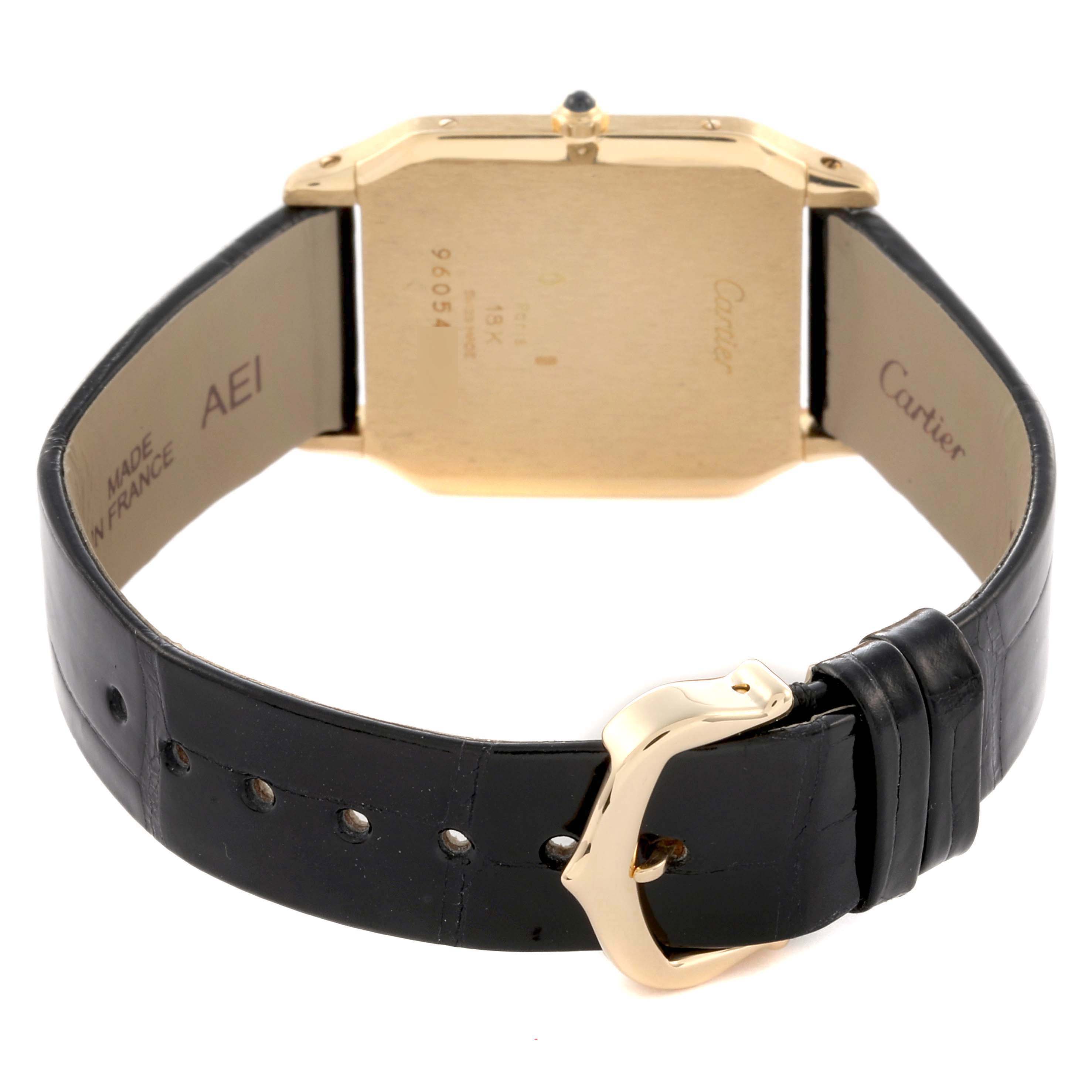 The Cartier Santos Dumont 15751 Men's Yellow Gold White Dial 15751 Men's Yellow Gold White Dial watch is shown from the back, highlighting the case, crown, and leather strap with buckle.