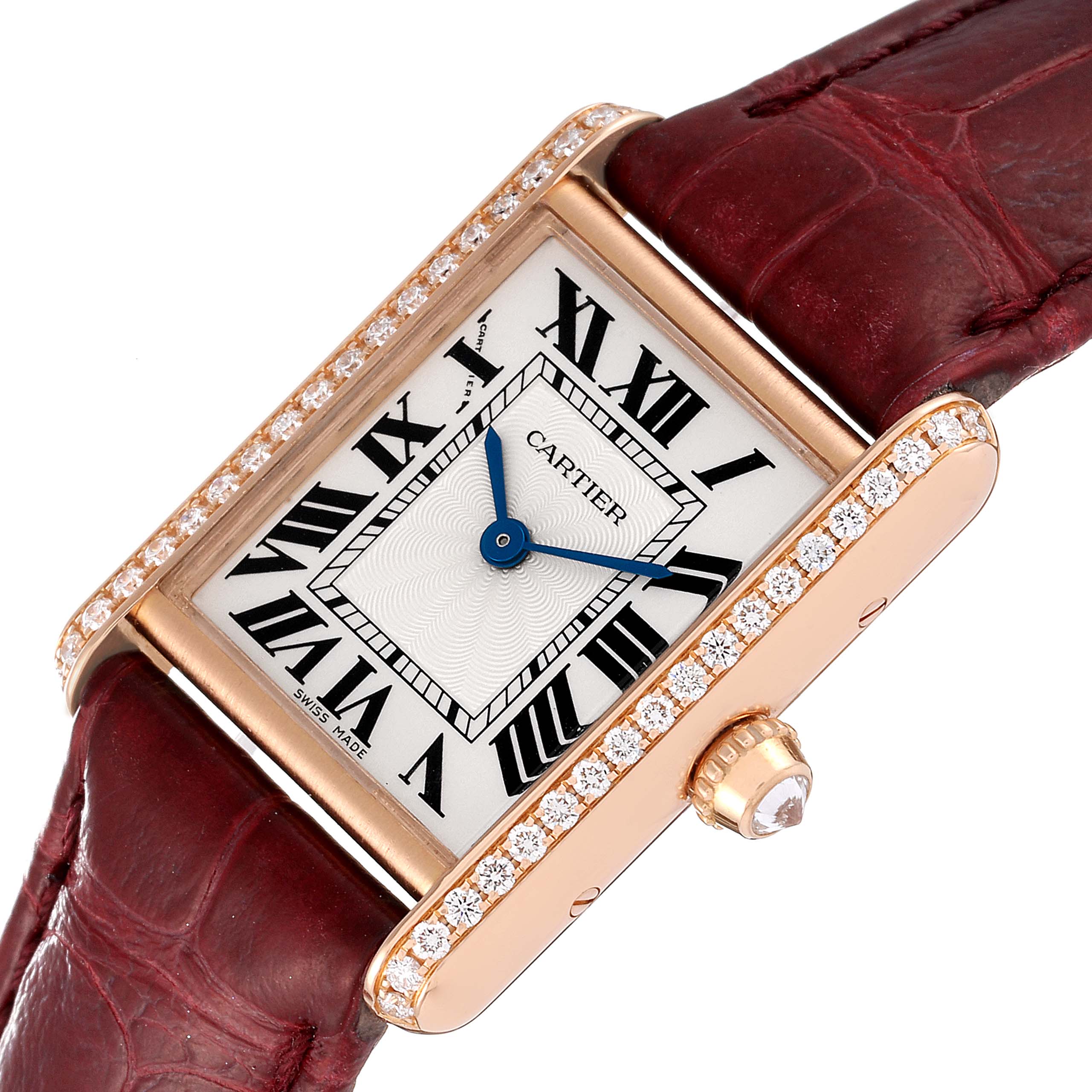 The Cartier Tank Louis WJTA0010 Women's Rose Gold Silver Dial WJTA0010 Women's Rose Gold Silver Dial watch is at a slight angle, showing the face, bezel with diamonds, and part of the maroon leather strap.