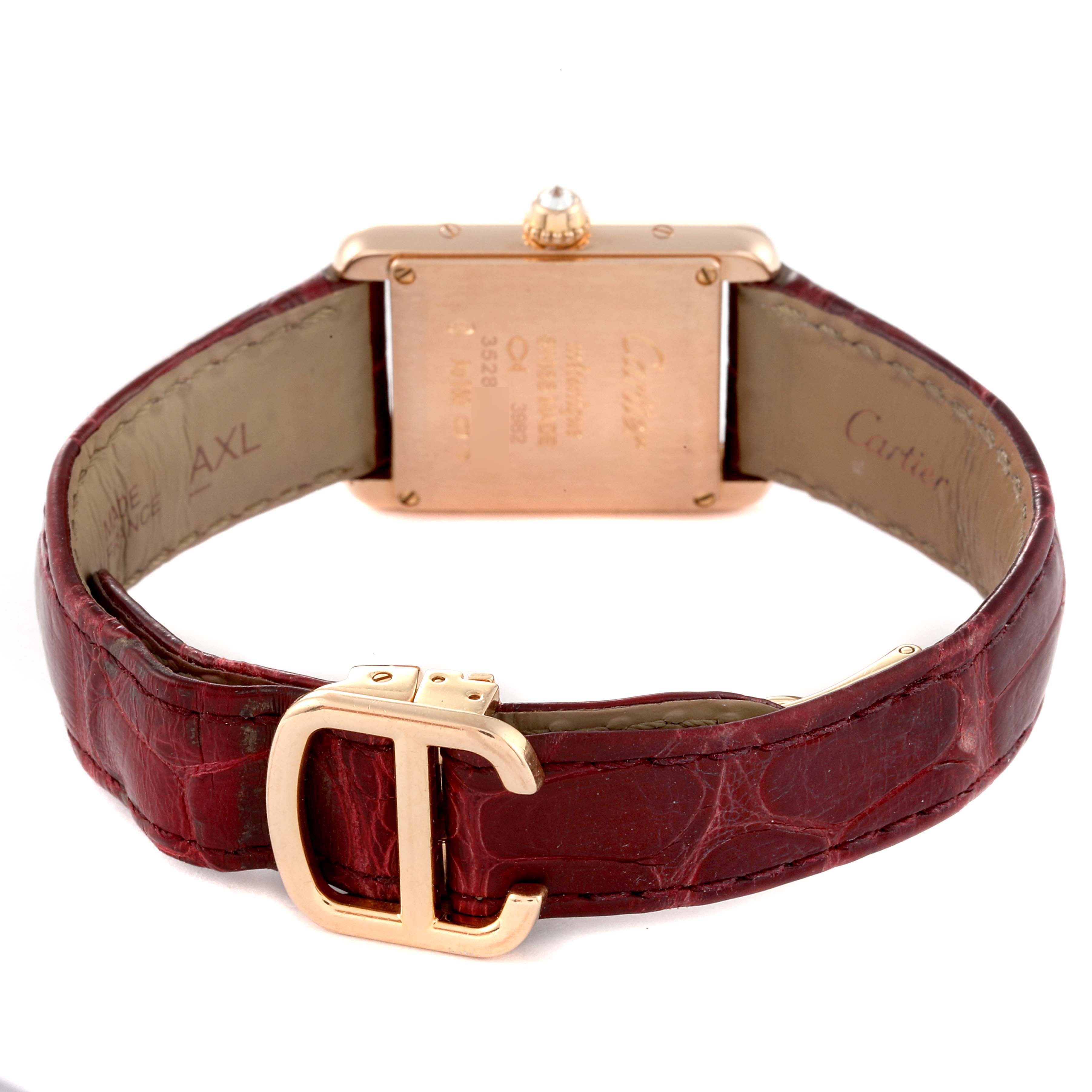 The image shows the back and strap of a Cartier Tank Louis WJTA0010 Women's Rose Gold Silver Dial WJTA0010 Women's Rose Gold Silver Dial watch, featuring a reddish leather band and a gold buckle.