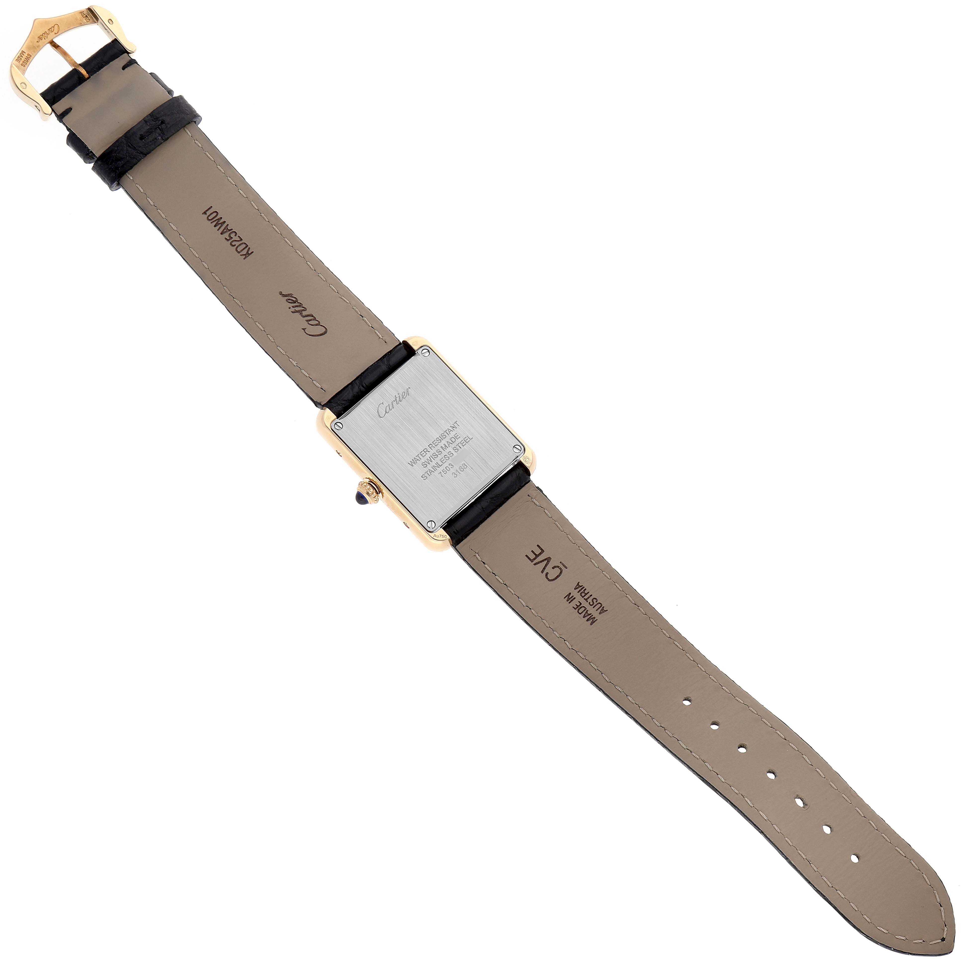 The image shows the back of the Cartier Tank Solo W5200002 Women's Yellow Gold Silver Dial W5200002 Women's Yellow Gold Silver Dial watch along with its leather strap and buckle, photographed from a top-down angle.