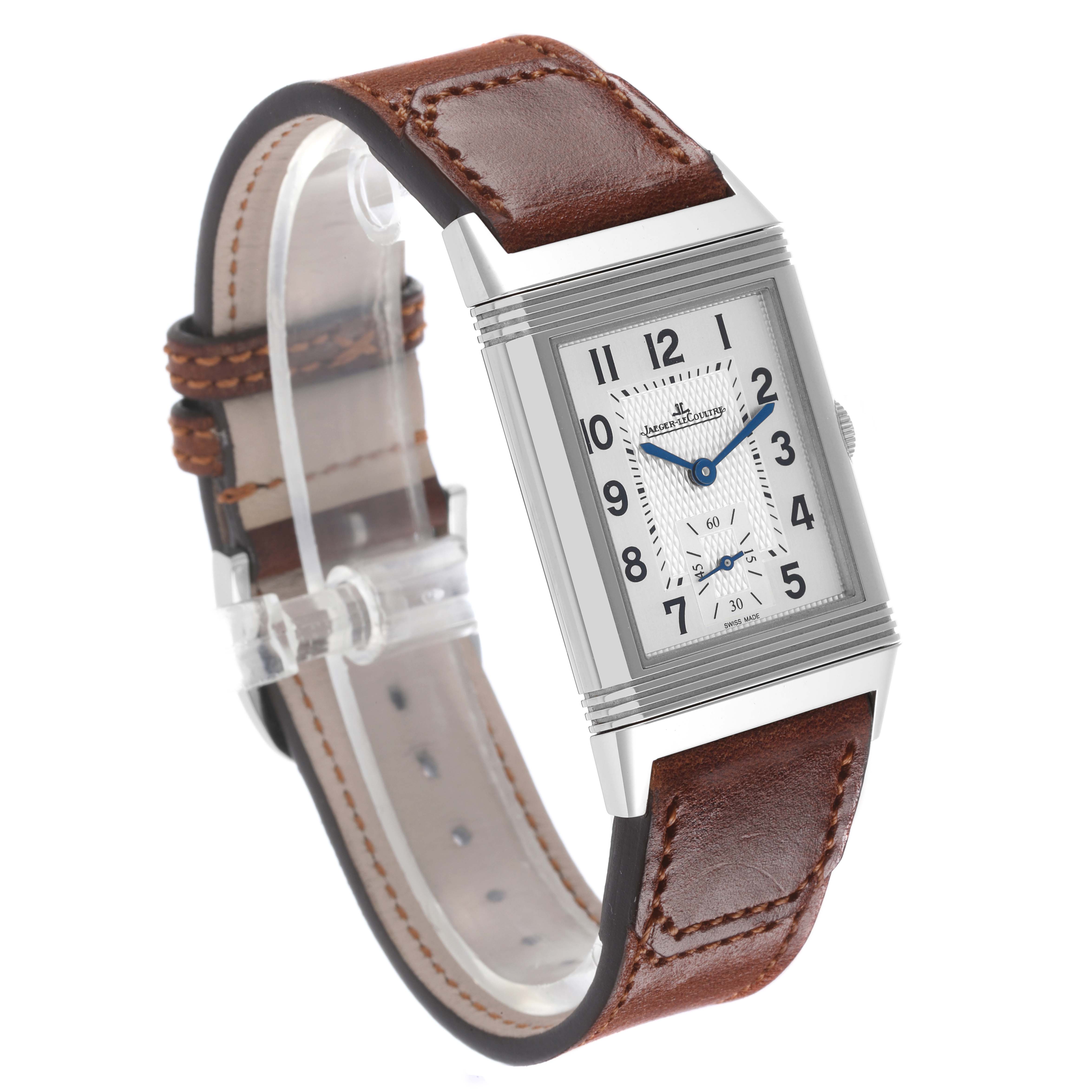 The Jaeger-LeCoultre Reverso watch is shown at a side angle, highlighting the face, case, crown, and brown leather strap.