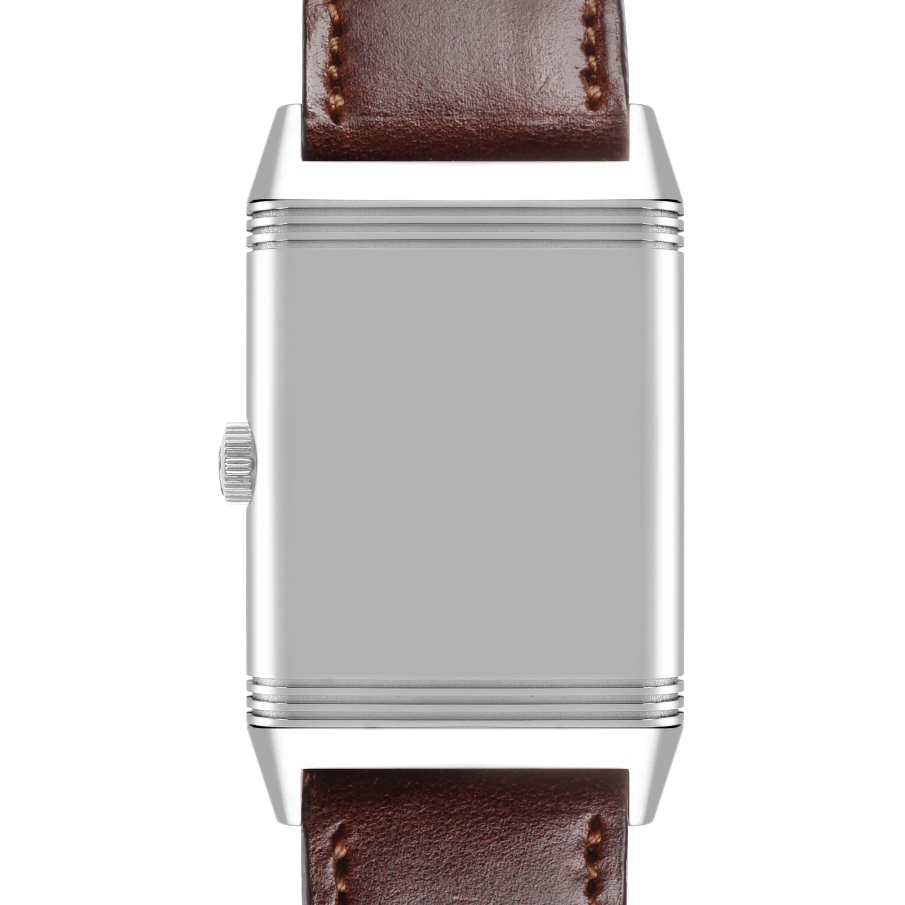 The Jaeger-LeCoultre Reverso watch is shown from a front angle, displaying the case, crown, and a brown leather strap.