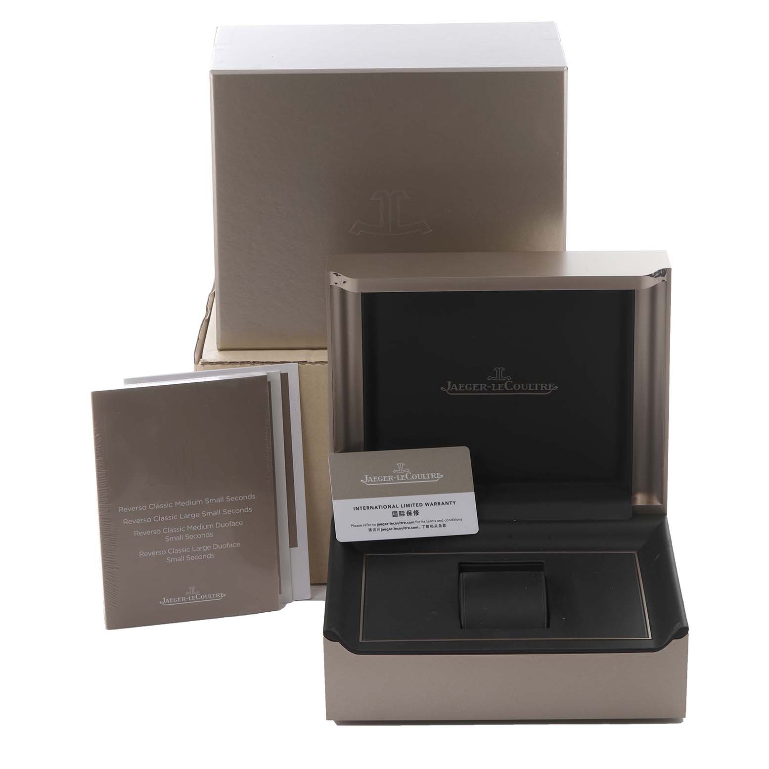 The image shows the packaging for a Jaeger-LeCoultre Reverso, including the box, booklets, and warranty card without the watch.