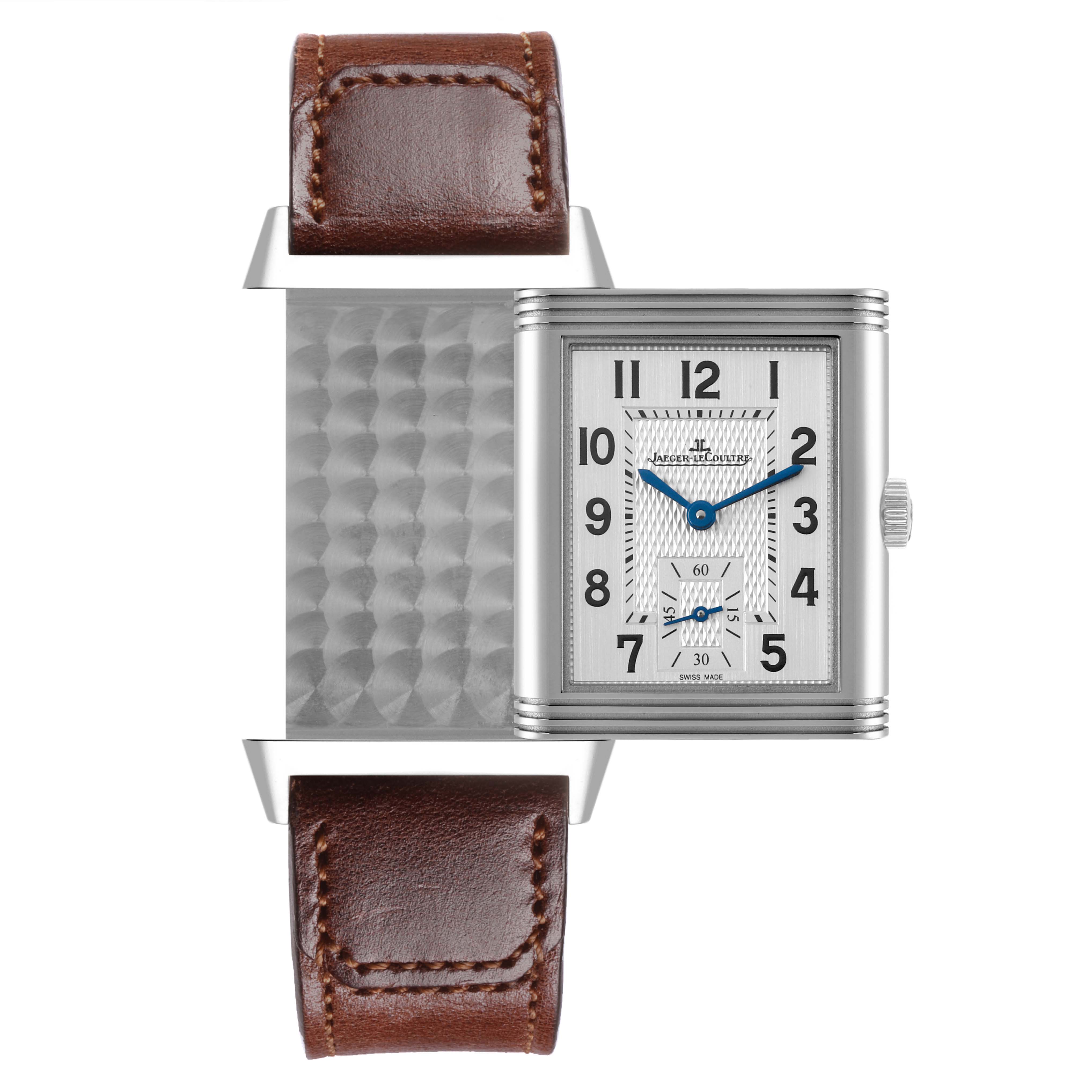 The Jaeger-LeCoultre Reverso watch is shown front-facing, revealing its reversible face and brown leather strap.
