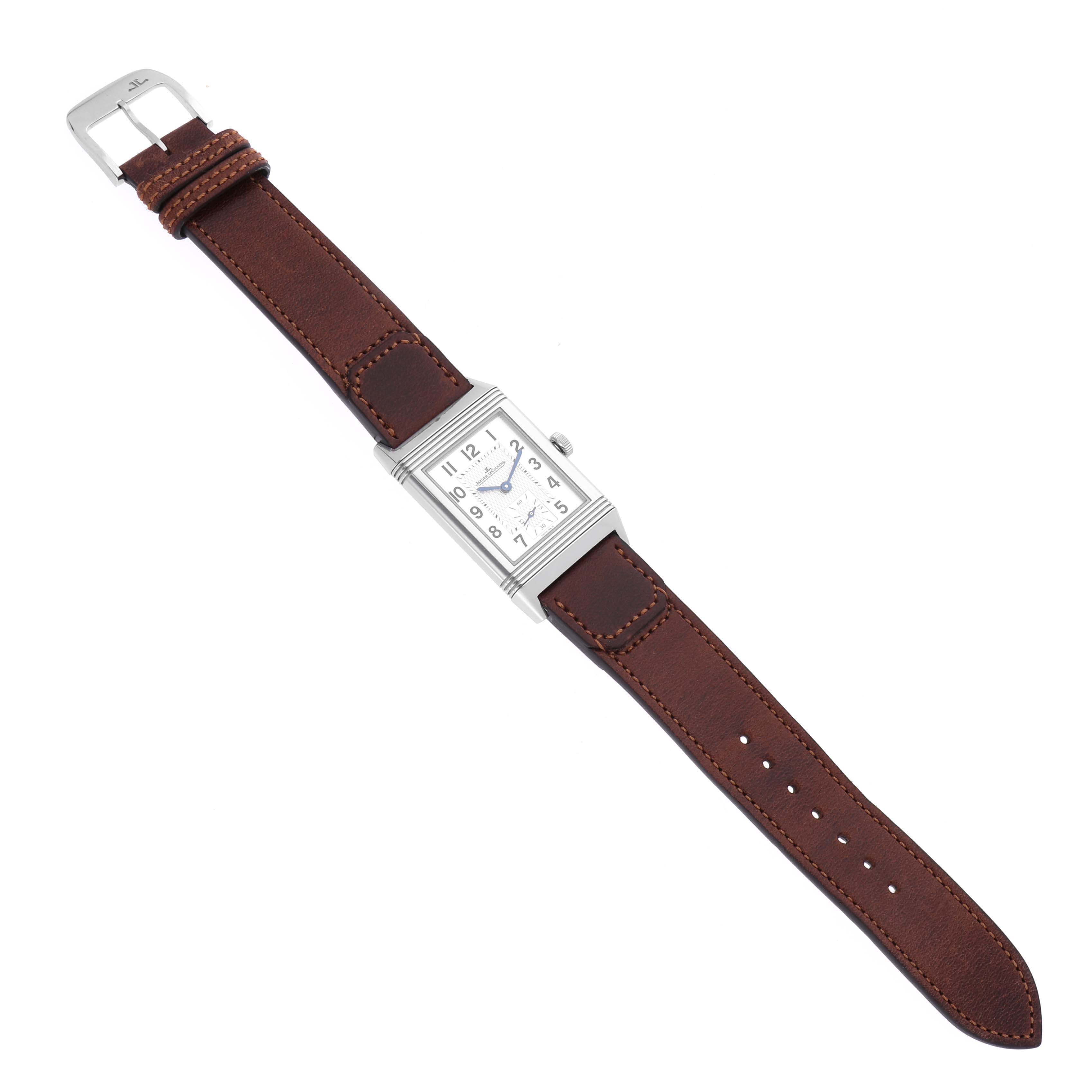 The Jaeger-LeCoultre Reverso watch is shown from a top-down angle, displaying the face, dial, case, and leather strap.